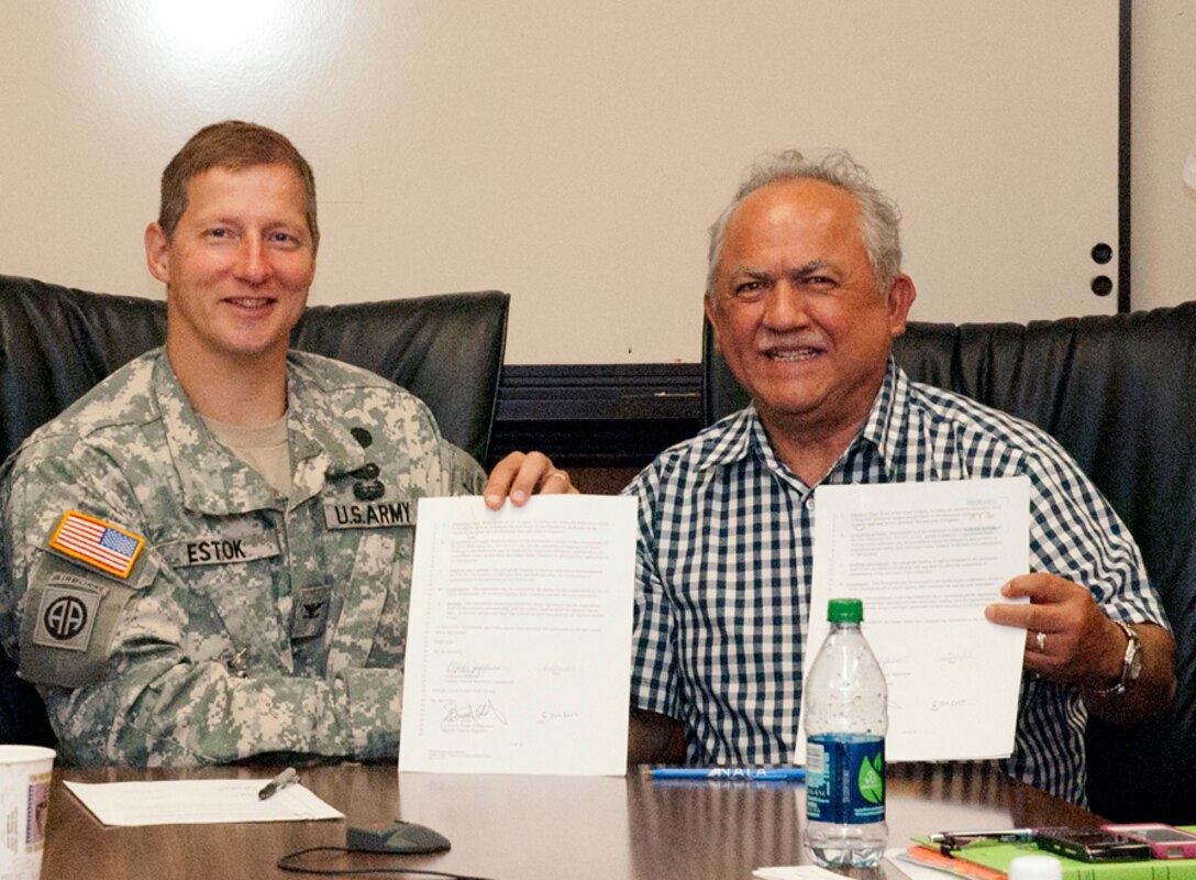 WASHINGTON — Col. Bruce Estok, U.S. Army Corps of Engineers Seattle District Commander, and Merle Jefferson, Lummi Natural Resource Department Executive Director, meet July 6, 2012 for final signatures. Federal agencies worked together with the Lummi Nation to establish the first federally authorized Native American sponsored commercial wetland and habitat mitigation bank in the nation.