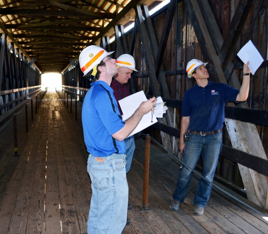 (From left) Chris Bayliss, Brad Ninnis and Christopher Abela, engineers with the U.S. Army Corps of Engineers Sacramento District, inspect the Knights Ferry Covered Bridge July 2, 2012 at Stanislaus River Parks near Oakdale, Calif. Engineers are working on a design to fix minor structural issues with the bridge, which was approved for inclusion as a historic landmark in the Library of Congress.