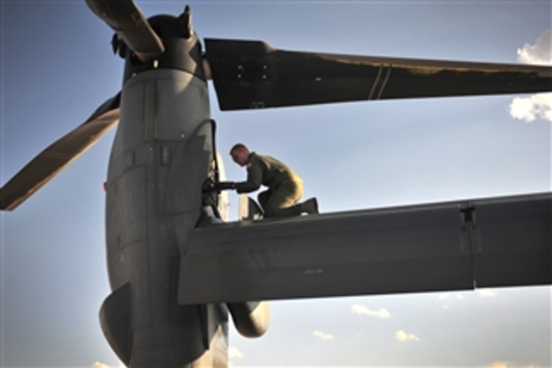 U. S. Air Force Staff Sgt. Casey Spang inspects one of the tilt-rotors on a CV-22 Osprey prior to takeoff from the flight line at Cannon Air Force Base, N.M., on July 5, 2012.  The 20th Special Operations Squadron conducted a routine training flight over Melrose Air Force Range, N.M.   Spang is a 20th SOS flight engineer. 