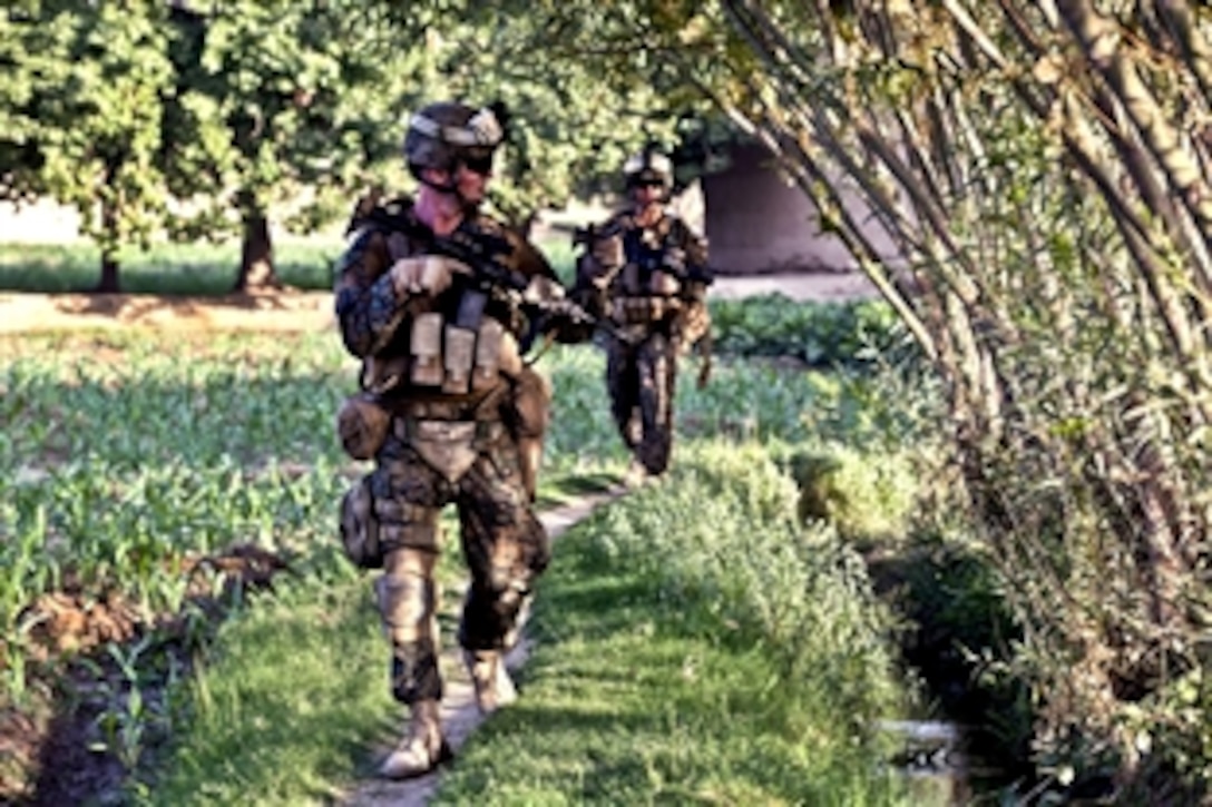 U.S. Navy Seaman Derek Happel, front, and U.S. Marine Corps Cpl. Alexander Vanny conduct a patrol in Sangin, Helmand province, Afghanistan, July 11, 2012. Happel, a hospitalman, and Vanny, a team leader, are assigned to 3rd Platoon, Alpha Company, 1st Battalion, 7th Marine Regiment, Regimental Combat Team 6. The Marines conducted the patrol in support of Afghan forces during Operation Gospand-Sia.