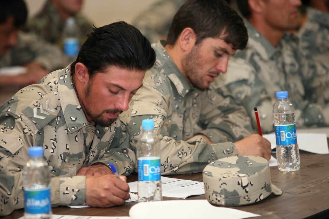 First Sgt. Khserwbic, left, a logistician with Zone 6 of the Afghan Border Police, takes notes during an administration course July 16, 2012. Nineteen members of the ANSF completed a two-week administration course that taught the students the basic functions of a military administration and personnel section.