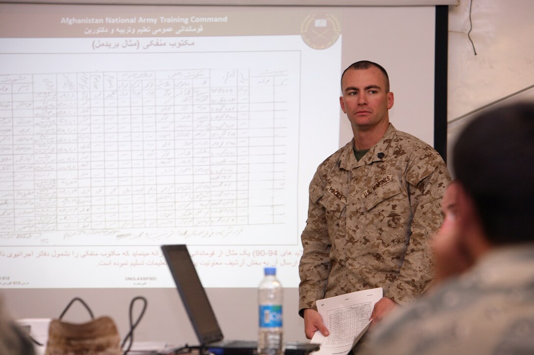 Staff Sgt. John R. Purcell, administrative course instructor and manpower operations chief at 1st MarDiv (Fwd), gives a class on absence-without-leave reporting procedures during an administration course July 16, 2012. Nineteen members of the ANSF completed a two-week administration course that taught the students the basic functions of a military administration and personnel section.