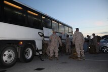 Marines with Marine Wing Support Squadron 272 load their packs underneath a bus prior to their departure to Marine Corps Air Ground Combat Center Twentynine Palms, Calif., for Enhanced Mojave Viper training, July 13. 