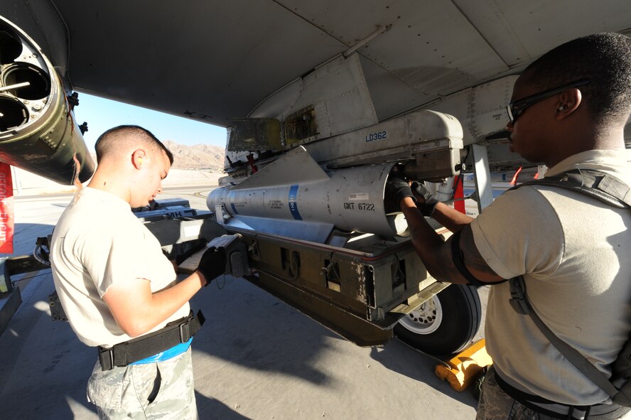 U.S. Staff Sgt. Robert Smith, 23d Aircraft Maintenance Squadron, 74th Aircraft Maintenance Unit, removes ordnance from an A-10C Thunderbolt II while Tech. Sgt. Anthony Spencer reviews the checklists for the load July 16, 2012, at Nellis Air Force Base, Nev., in support of Red Flag 12-4 exercise.  The experience gained at Red Flag by the weapons loaders offers the opportunity to load live ordnance not used at home station.  (U.S. Air Force photo by Master Sgt. Sonny Cohrs/Released)