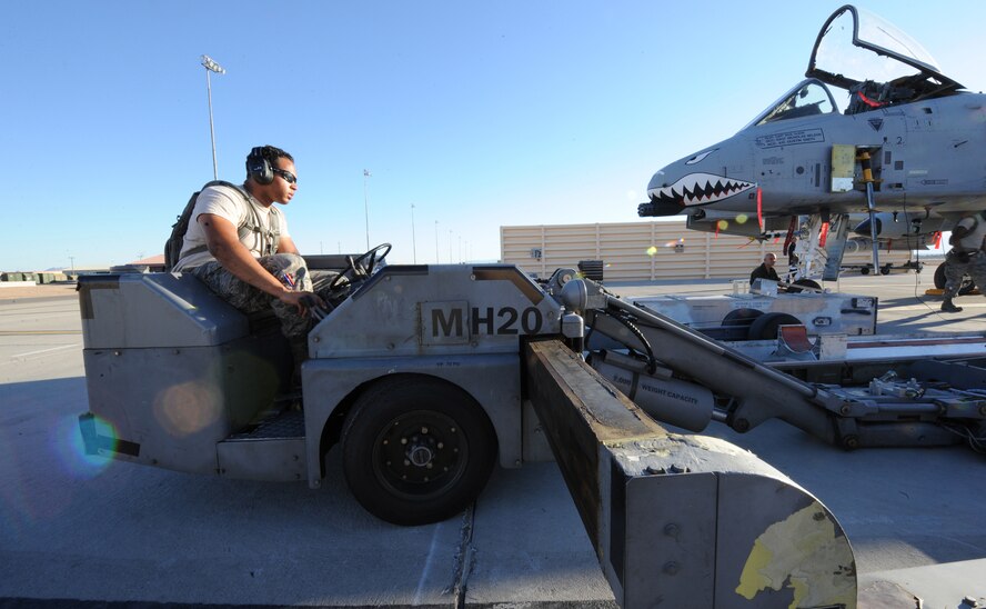 U.S. Air Force Senior Airman Michael Tomaski, 23d Aircraft Maintenance Squadron, 74th Aircraft Maintenance Unit, drives an MHU-83 bomb lift truck into position for unloading ordnance from an A-10C Thunderbolt II, July 16, 2012, at Nellis Air Force Base, Nev., during Red Flag 12-4 exercise. The A-10C weapons loaders here work in three-man load crews to get aircraft armed up for missions at the nearby Nevada Test and Training Range.  (U.S. Air Force photo by Master Sgt. Sonny Cohrs/Released)
