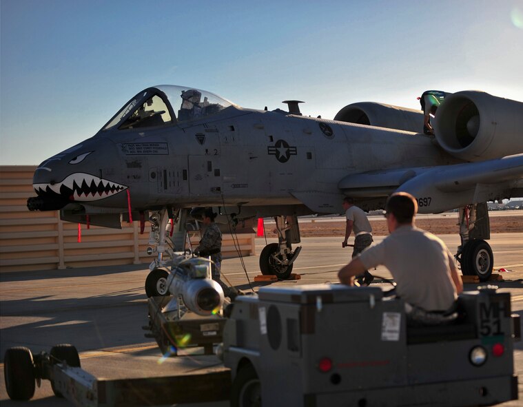 U.S. Air Force Staff Sgts. Bobby Corso (driver), Eleanor Moore and Senior Airman Christopher Tarbart, 23d Aircraft Maintenance Squadron weapons armament systems specialists, remove and secure an AG M65 Maverick munition off an A-10C Thunderbolt II during Red Flag 12-4 exercise at Nellis Air Force Base, Nev., July 16, 2012. A three man weapons load crew removed an AG M65 Maverick munition off an A-10 during its thru-flight inspection. (U.S. Air Force photo by Staff Sgt. Stephanie Mancha/Released)