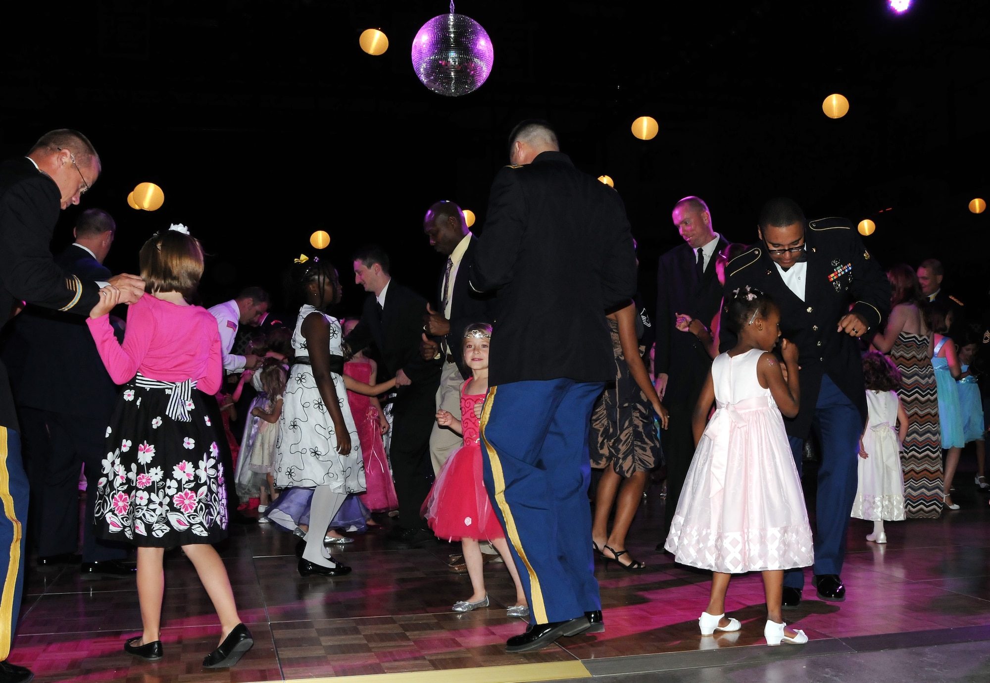 Children and their dads dance to music during the Annual Father Daughter Dance July 7, 2012, Fairbanks, Alaska. The annual event, hosted by the Armed Services YMCA, gives fathers a chance to treat their daughters like princesses for an evening. (U.S. Air Force photo/Senior Airman Janine Thibault)
