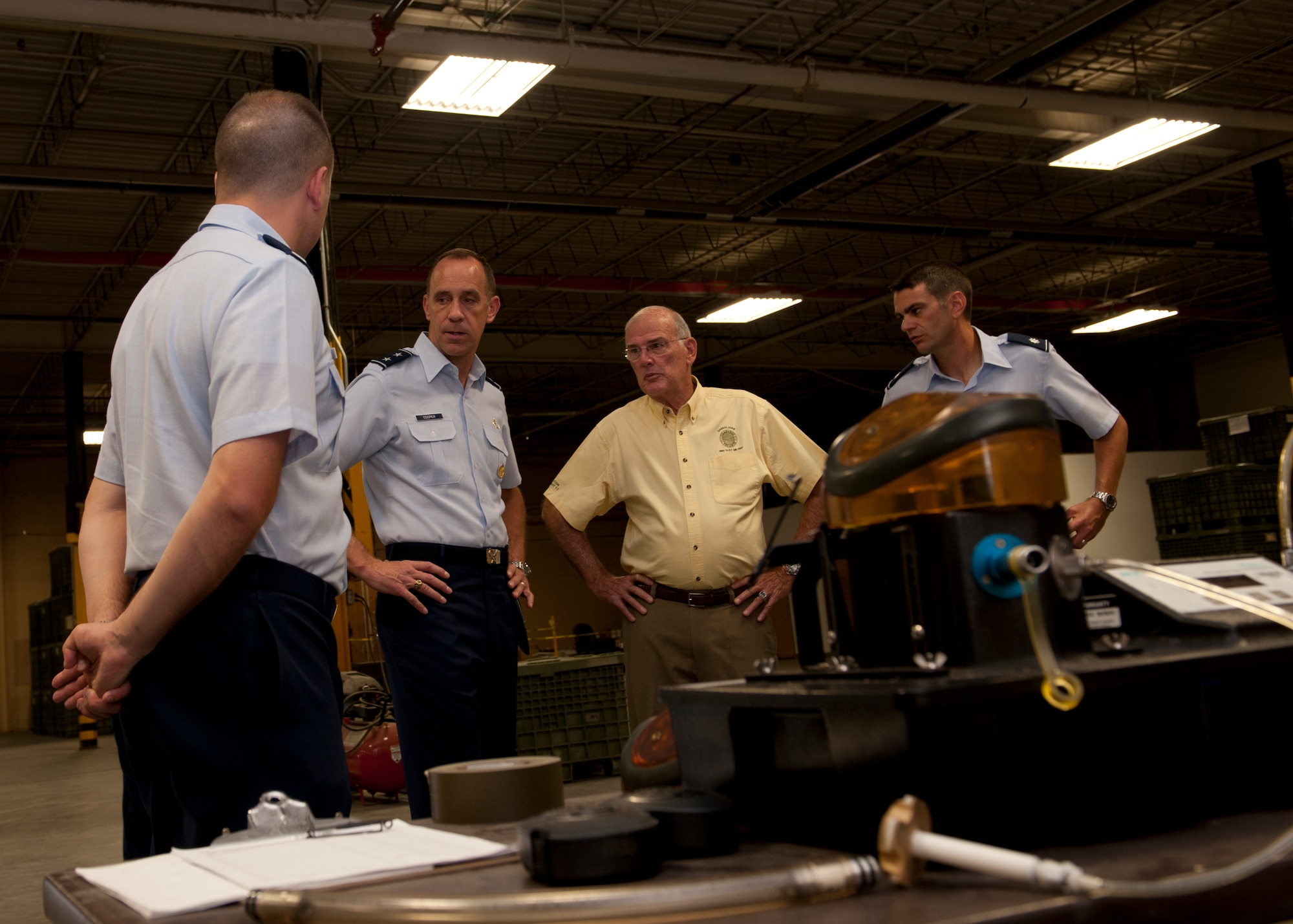 Airmen from the 49th Logistics Readiness Squadron speak to Maj. Gen. John Cooper and Maj. Gen. (Ret.) Bruce Smith about the squadron’s operations during Cooper and Smith’s visit to Holloman Air Force Base, N.M., July 16. Smith and Cooper visited the base to look at 49th LRS operations and to award the squadron with the Maj. Gen. Warren R. Carter Logistics Effectiveness Award, which named them the best logistics readiness squadron in the U.S. Air Force for 2011. Cooper is the director of logistics, deputy chief of staff for logistics, Installations and Mission Support, Headquarters U.S. Air Force, Washington, D.C., and Smith is the chairman of the Board of Trustees, Order of the Daedalians Foundation. (U.S. Air Force photo by Airman Leah Ferrante/Released)