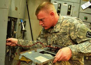 U. S. Army Sgt. Justin Kaplan, senior watercraft engineman on the U.S. Army Vessel Landing Craft Utility 2023, performs maintenance inside an electrical panel in the lower deck of the 'Hobkirk' during a maintenance inspection June 22. Kaplan is responsible for the maintenance of the electrical equipment, engine, fuel, water pipes, and other maintenance needs on the boat. (U.S. Army photo by Sgt. Edwin J. Rodriguez/Released)