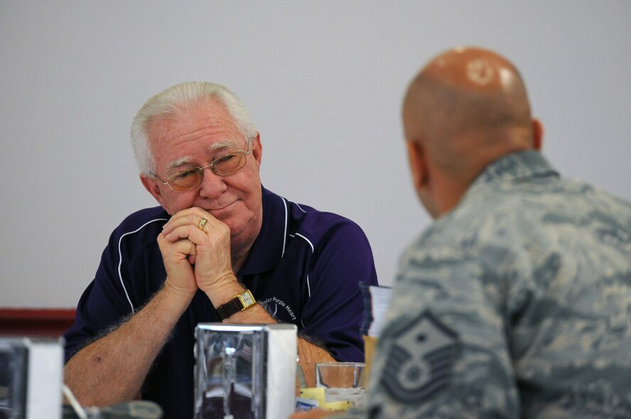 Master Sgt. David Bedner, 2nd Medical Group first sergeant, asks Richard Garner, Department of Louisiana Military Order of the Purple Heart commander, a question at the Red River Dining Facility on Barksdale Air Force Base, La., July 17. Garner visited Barksdale to speak to Airmen about his encounter as an infantryman during the Vietnam War. Garner received the Silver Star and the Purple Heart for his heroic actions in combat. (U.S. Air Force photo/Airman 1st Class Micaiah Anthony)(RELEASED)