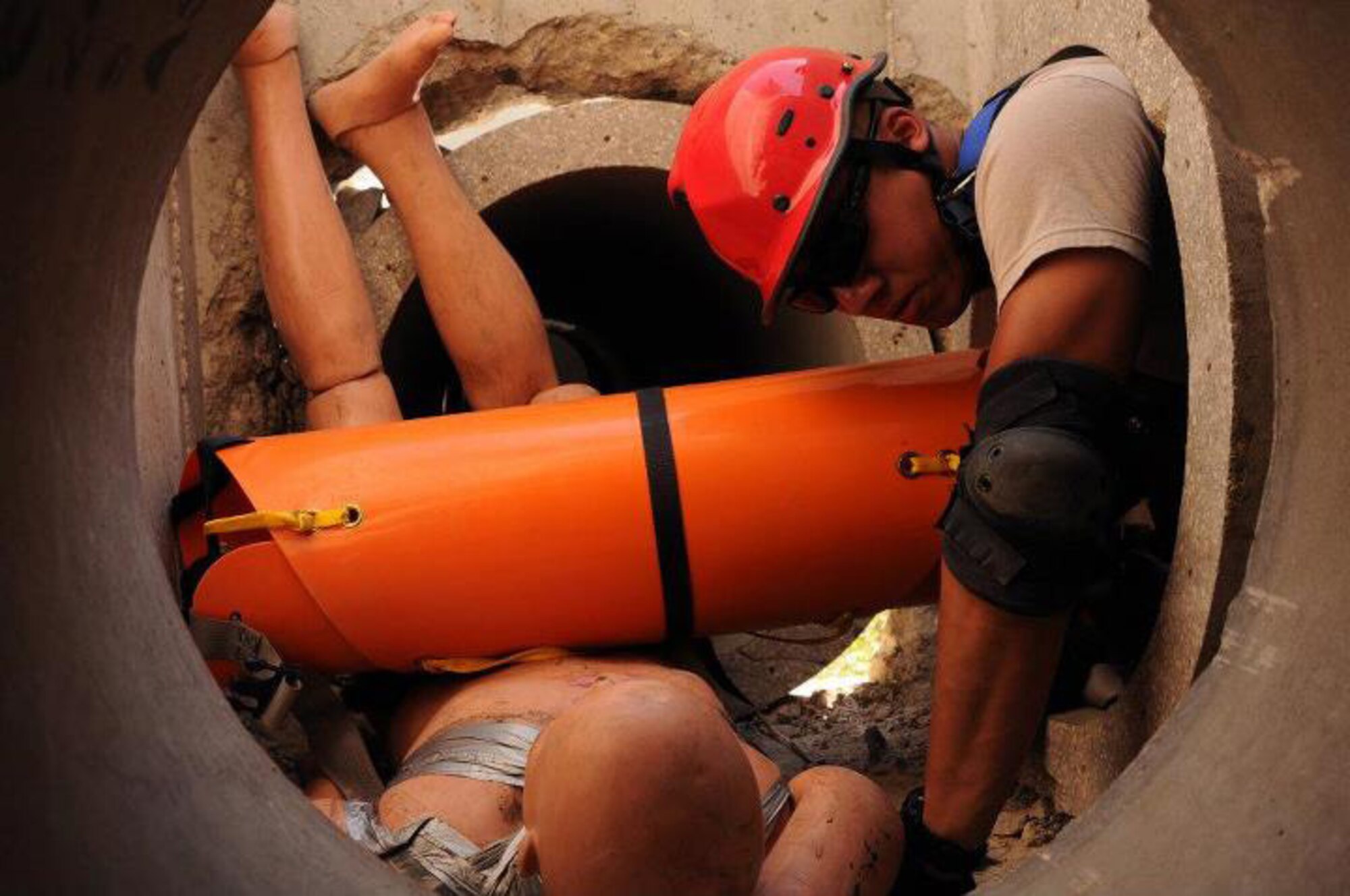 Army National Guard Spc. Nicky Lamb, 21st Civil Support Team, New Jersey, crawls through a concrete cylinder to rescue a simulated victim while being tested by instructors from the Wisconsin Regional Emergency All-Climate Training Center during PATRIOT 12 at Volk Field, Wis., July 17, 2012. The PATRIOT 12 exercise gives 1,100 guard personnel from 15 states the opportunity to integrate with local and state agencies during valuable training simulations. (National Guard photo by Airman 1st Class Penny Hamilton/Released)
