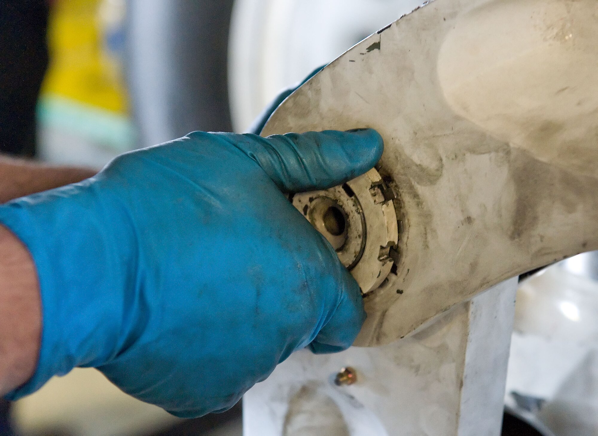 Staff Sgt. Aaron Romero, an aero repair technician with the 436th Maintenance Squadron, tightens a nut on a pin July 16, 2012, at Dover Air Force Base, Del. The pin and nut secure main landing gear components critical for proper operation. (U.S. Air Force photo by Roland Balik)
