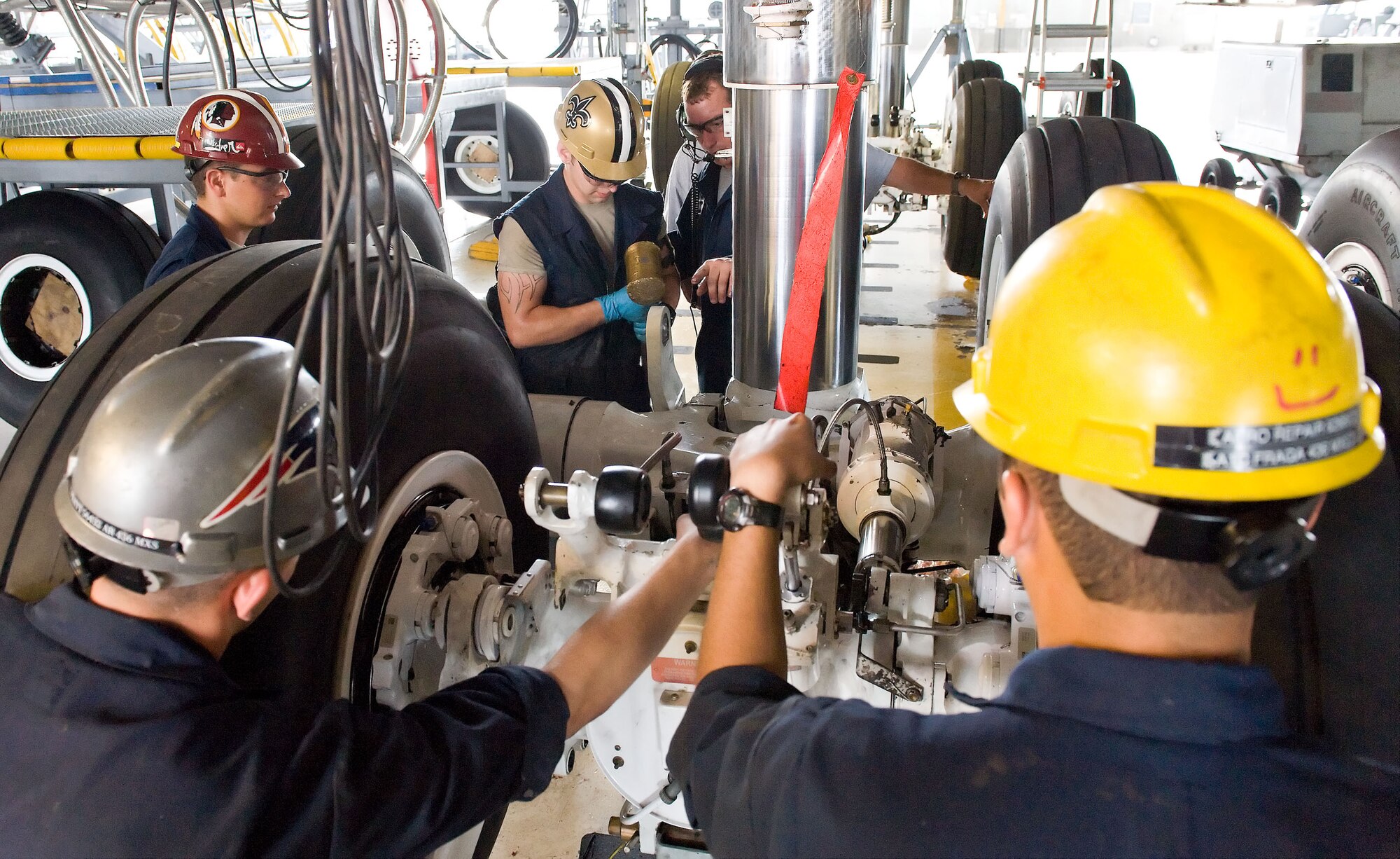 Members of the 436th Maintenance Squadron isochronal aero repair team assemble a C-5 main landing gear bogie assembly July 16, 2012, at Dover Air Force Base, Del. The five-man team re-attached the main landing gear wheel assembly after performing required maintenance. (U.S. Air Force photo by Roland Balik)
