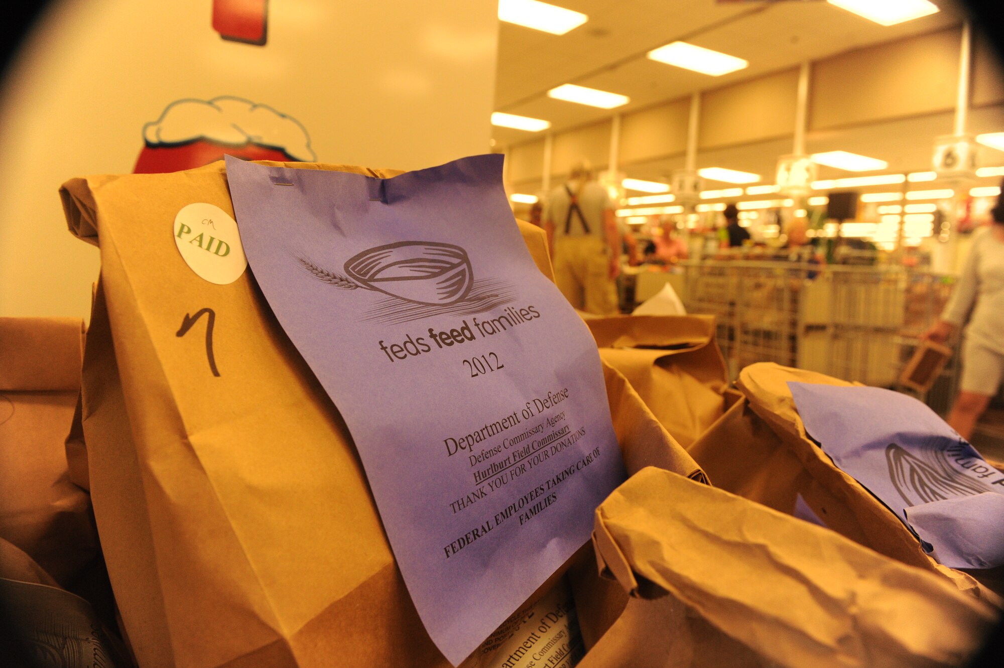 A pre-packed donation bag of food for the Feds Feed Families campaign rests in a bin at the base commissary at Hurlburt Field, Fla., July 18, 2012. The commissary is selling $10 bags of food for customers to donate. (U.S. Air Force photo/Senior Airman Eboni Reams)(Released)