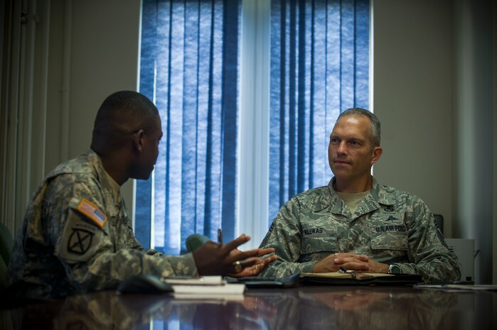 Sgt. Maj. Kelly Hill, 841st Transportation Battalion sergeant major (left), briefs Chief Master Sgt. Martin Klukas, U.S. Transportation Command senior enlisted leader, Scott Air Force Base, Ill., on USTRANSCOM operations during Klucas’ visit to the 841st Transportation Battalion at Joint Base Charleston - Weapons Station, S.C., July 13, 2012. Klukas is the principal advisor to the combatant commander for all matters concerning joint force integration, career development, utilization and sustainment of more than 150,000 enlisted personnel serving USTRANSCOM's air, land and sea components throughout the world. (U.S. Air Force photo by Airman 1st Class George Goslin)