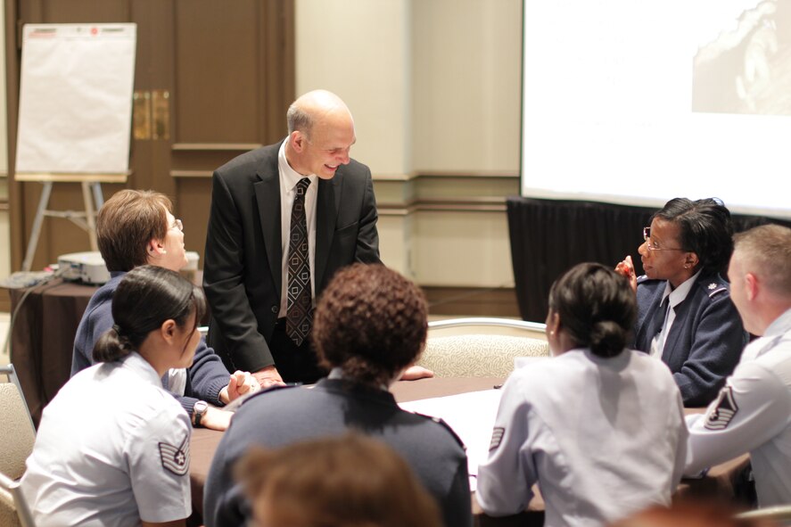 AFMS attendees engaged in a wide variety of leadership and problem
solving exercises at the 2012 Executive Leadership Symposium and workshop on
26 Apr 2012. Workshop topics were aimed at introducing new or honing
existing problem solving methods for leaders who will deliver topics and
techniques back to their units. Pictured here Mr. Michael Rubell, an
independent leadership and teamwork consultant, discusses problem solving
skills with a group of attendees. (Air Force Photo)
