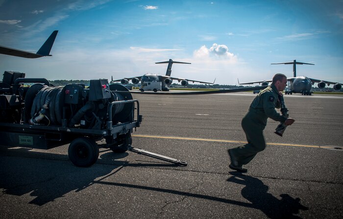 Master Sgt. Samuel Strong, 628th Logistics Readiness Squadron Fuels Flight, Forward Area Refueling Point team, gives a demonstration of FARPs operations for Chief Master Sgt. Martin Klukas, U.S. Transportation Command senior enlisted leader, from Scott Air Force Base, Ill., during his visit to Joint Base Charleston – Air Base, S.C., July 12, 2012. The FARPs mission is to hot refuel, which is to refuel while the engines are operating, from a tanker aircraft (C-17 Globemaster III) to a receiver aircraft, under the cover of darkness in an austere environment. Klukas is the principal advisor to the combatant commander for all matters concerning joint force integration, career development, utilization and sustainment of more than 150,000 enlisted personnel serving USTRANSCOM's air, land and sea components throughout the world. (U.S. Air Force photo/Airman 1st Class Ashlee Galloway)