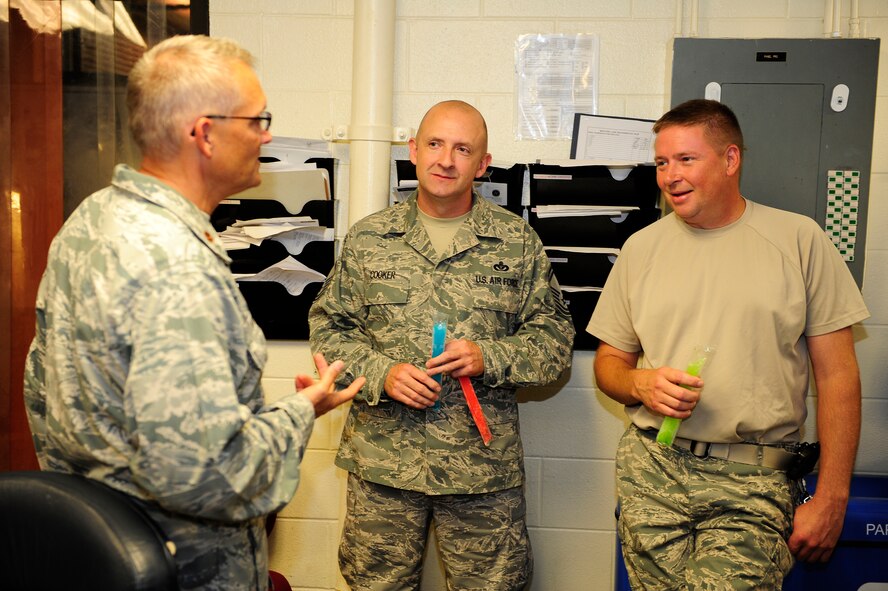 Chaplain (Maj.) David Knight (left), 20th Fighter Wing flight line chaplain, speaks with Senior Master Sgt. Steven Cooker (center), 20th Civil Engineer Squadron heating ventilation and air conditioning NCOIC, and Tech. Sgt. William Brown, 20th CES assistant HVAC NCOIC, about how their squadron and daily duties are going at Shaw Air Force Base, S.C., July 16, 2012. Chaplains and their assistants get out and among Team Shaw to help in any way they can as they connect on the personal level. (U.S. Air Force photo by Airman 1st Class Daniel Blackwell/Released) 
