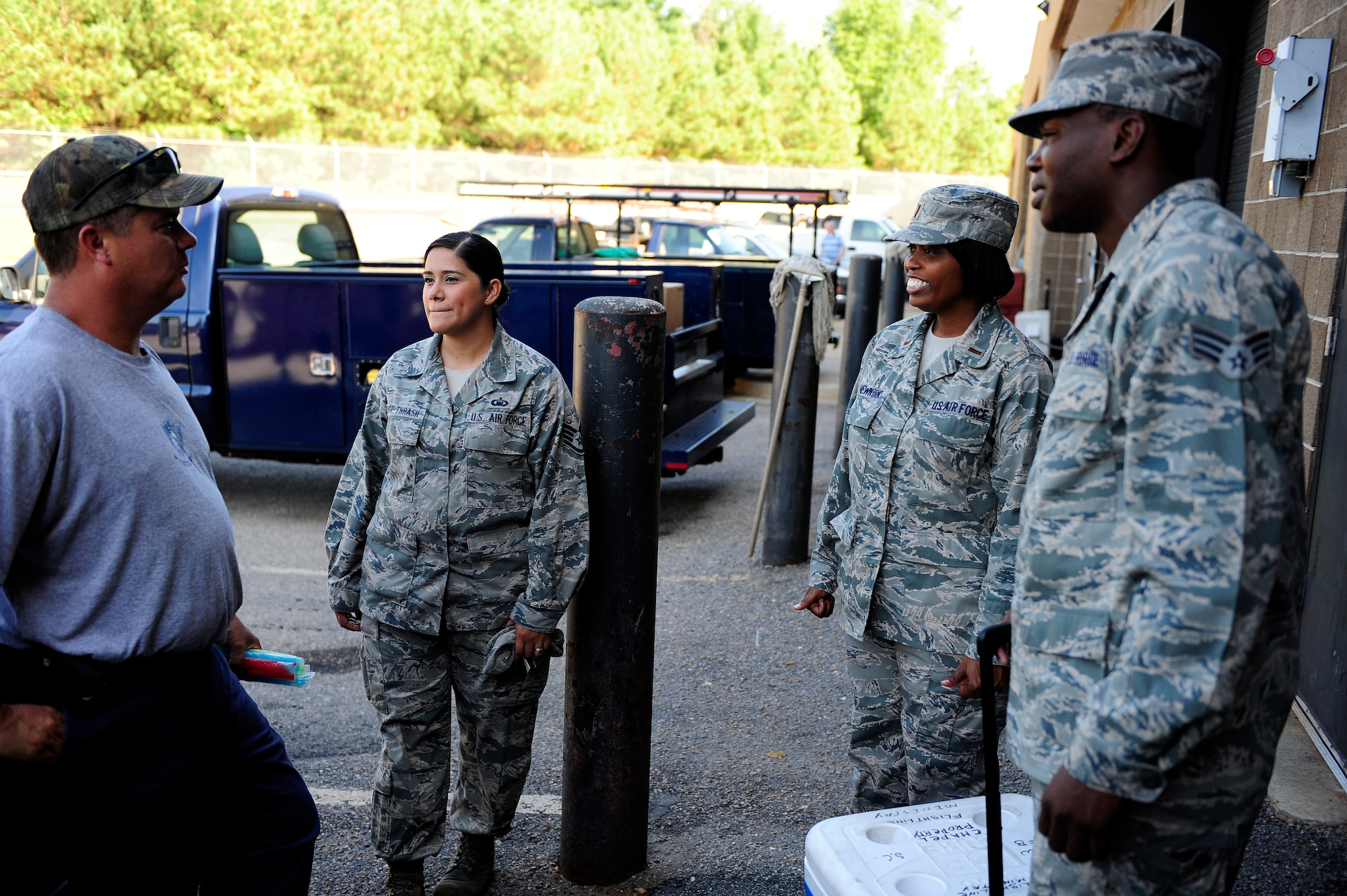 Chapel staff offer freeze pops and speak with Frank Shaw, 20th Civil Engineer Squadron electronic industrial controls mechanic, as they get to know members of Team Shaw at Shaw Air Force Base, S.C., July 16, 2012 .  Combining three chapel services into one will give the chapel staff more time for contact ministry like this throughout the base. (U.S. Air Force photo/Airman 1st Class Daniel Blackwell/Released)