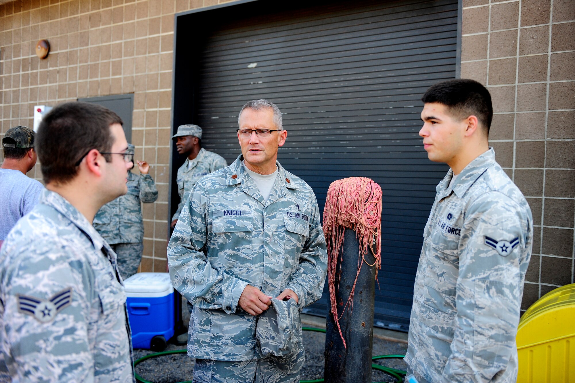 Chaplain (Maj.) David Knight, 20th Fighter Wing flight line chaplain, speaks with Senior Airman Mark Shoup (left) and Airman 1st Class Antonio Griego, 20th Civil Engineering Squadron heating ventilation and air conditioning specialists, about their work at Shaw Air Force Base, S.C., July 16, 2012. The wing chapel staff routinely visits Airmen and Soldiers across the base, to stay in touch with and minister to wants, needs, morale and any concerns they may have. (U.S. Air Force photo/Airman 1st Class Daniel Blackwell/Released)