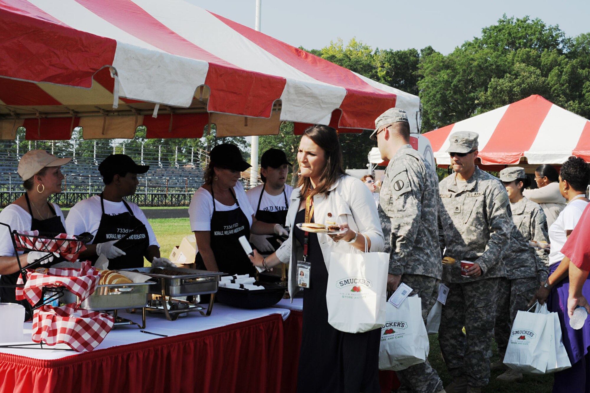 Volunteers serve breakfast to attendees of the Smucker’s Mission Breakfast at Fort Eustis, Va., July 17, 2012. The event was open to all Service members, retirees and dependents. (U.S. Air Force photo by Staff Sgt. Ashley Hawkins/Released)