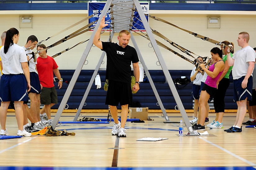 Mike Skaggs, Total Resistance Exercise instructor, leads a group of participants during a demonstration at Langley Air Force Base, Va., Shellbank Fitness Center, July 11, 2012.  TRX uses vectoring through the use of body angles, stability training and the pendulum effect to offer exercises tailored for the military lifestyle.  (U.S. Air Force photo by Airman 1st Class Kayla Newman/Released)