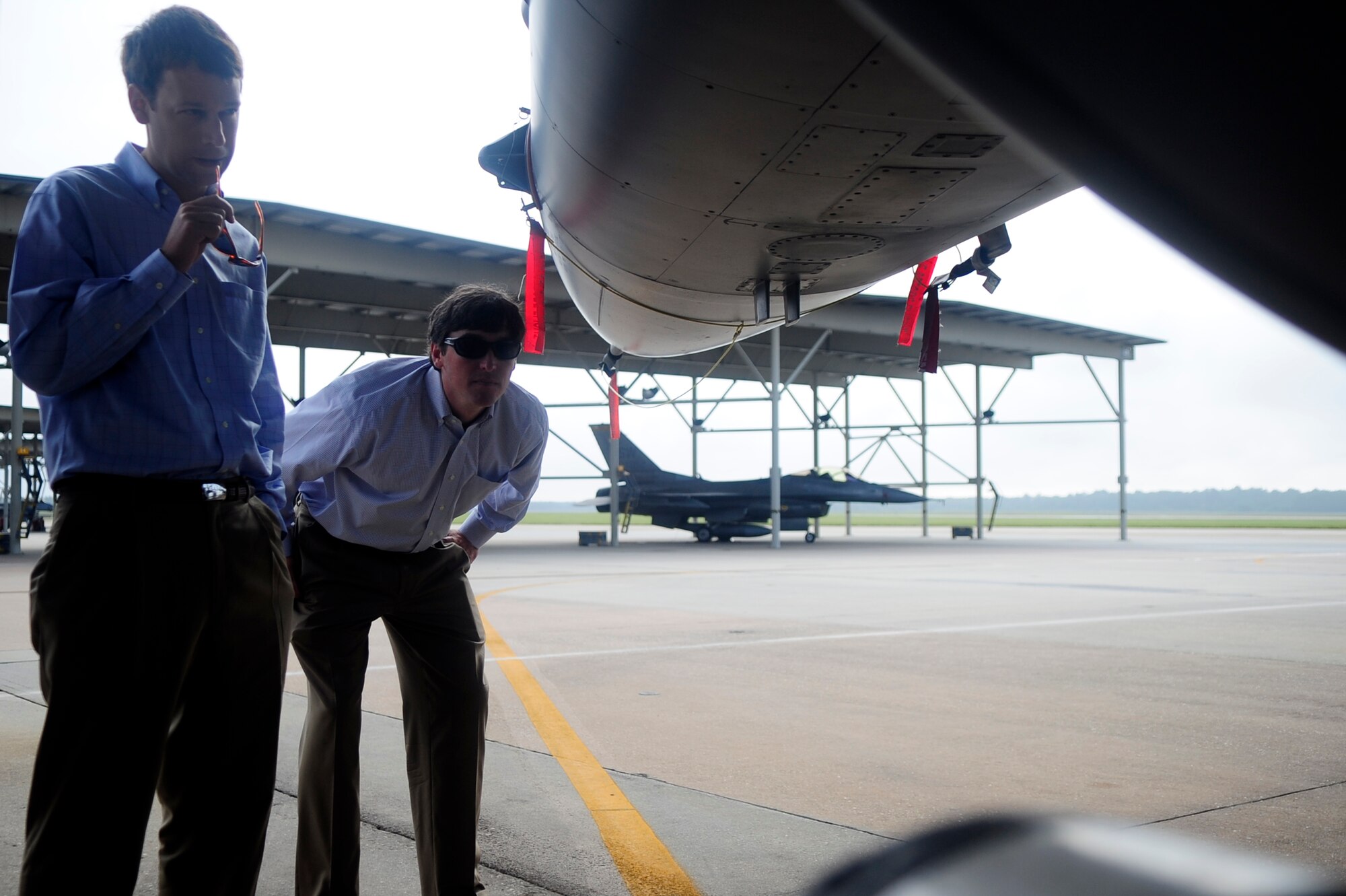 Cam Smith and Andy Folsom, Salute from the Shore members, check out an F-16 Fighting Falcon on the flightline at Shaw Air Force Base, S.C., July 11, 2012. Salute from the Shore organization members received a tour of the 79th Fighter Squadron, got hands on with an F-16 and got to watch the jets launch off of the flightline. (U.S. Air Force photo/Senior Airman Daniel Phelps/Released)