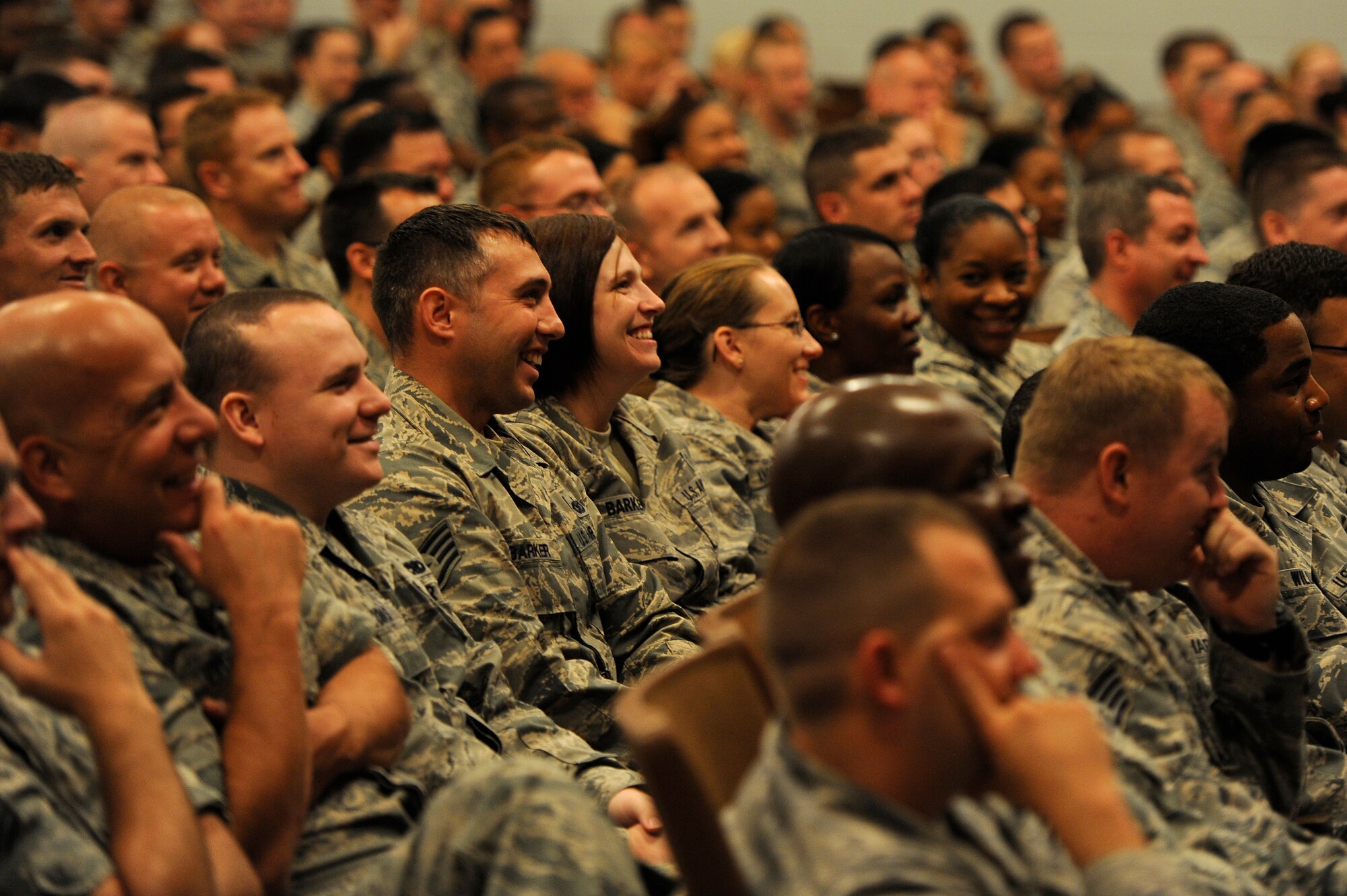 U.S. Air Force Airmen assigned to the 20th Fighter Wing laugh during an enlisted all call held by Chief Master Sgt. James Wilkerson, 20th Fighter Wing command chief, July 13, 2012, Shaw Air Force Base, S.C. Wilkerson held the enlisted all call to present the senior enlisted perspective of the 20th FW Commander’s message and intent while soliciting feedback and directly answering questions from the Airmen. (U.S. Air Force photo by Senior Airman Kenny Holston/Released) 