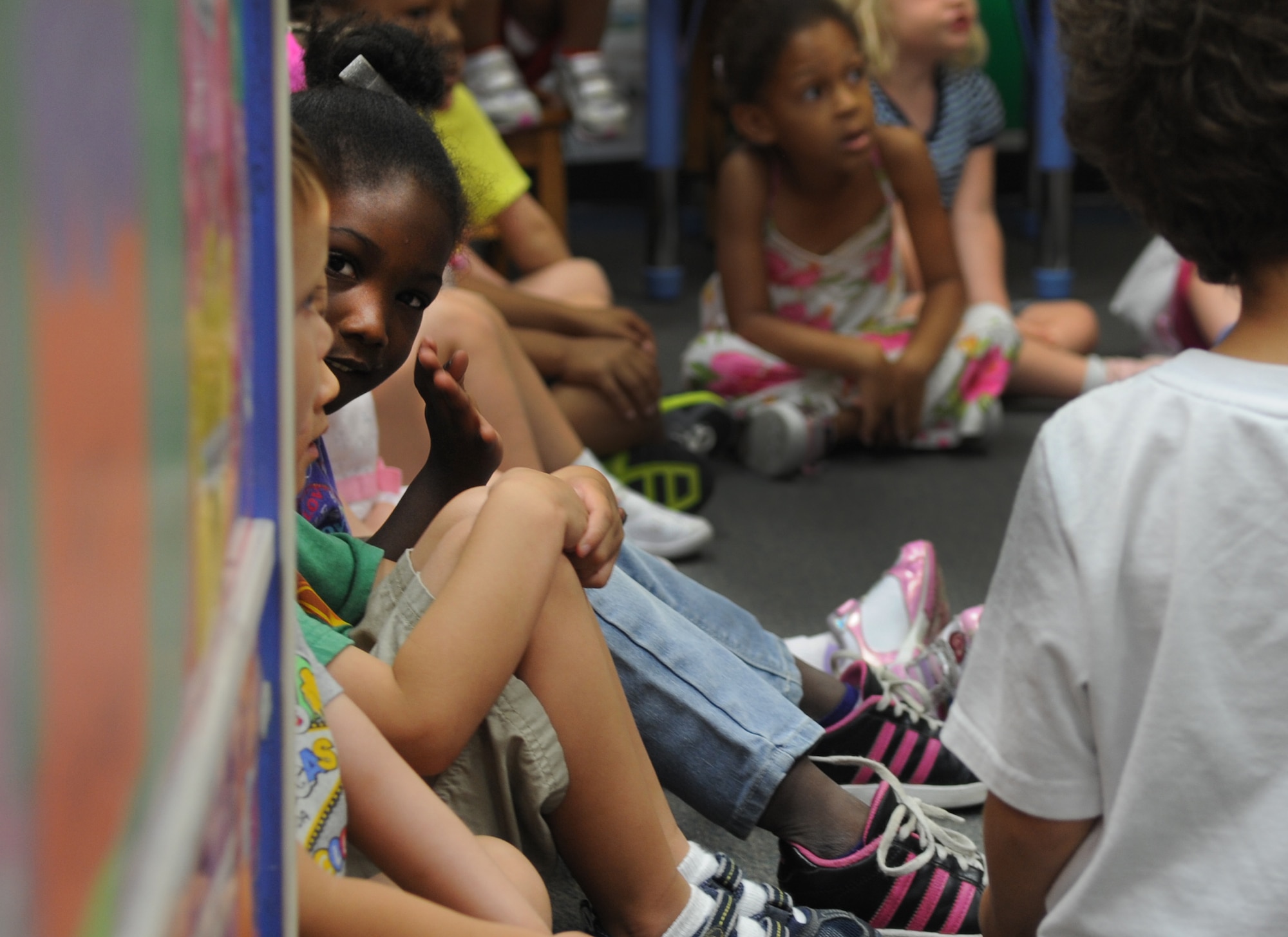 Children sit and listen as a story is read to them at the Langley Air Force Base, Va. Child Development Center, July 17, 2012. The reading was part of an event organized by the Family Advocacy Outreach Office in support of “Make a Difference to Children” month. (U.S. Air Force photo by Senior Airman Jarad A. Denton/Released)