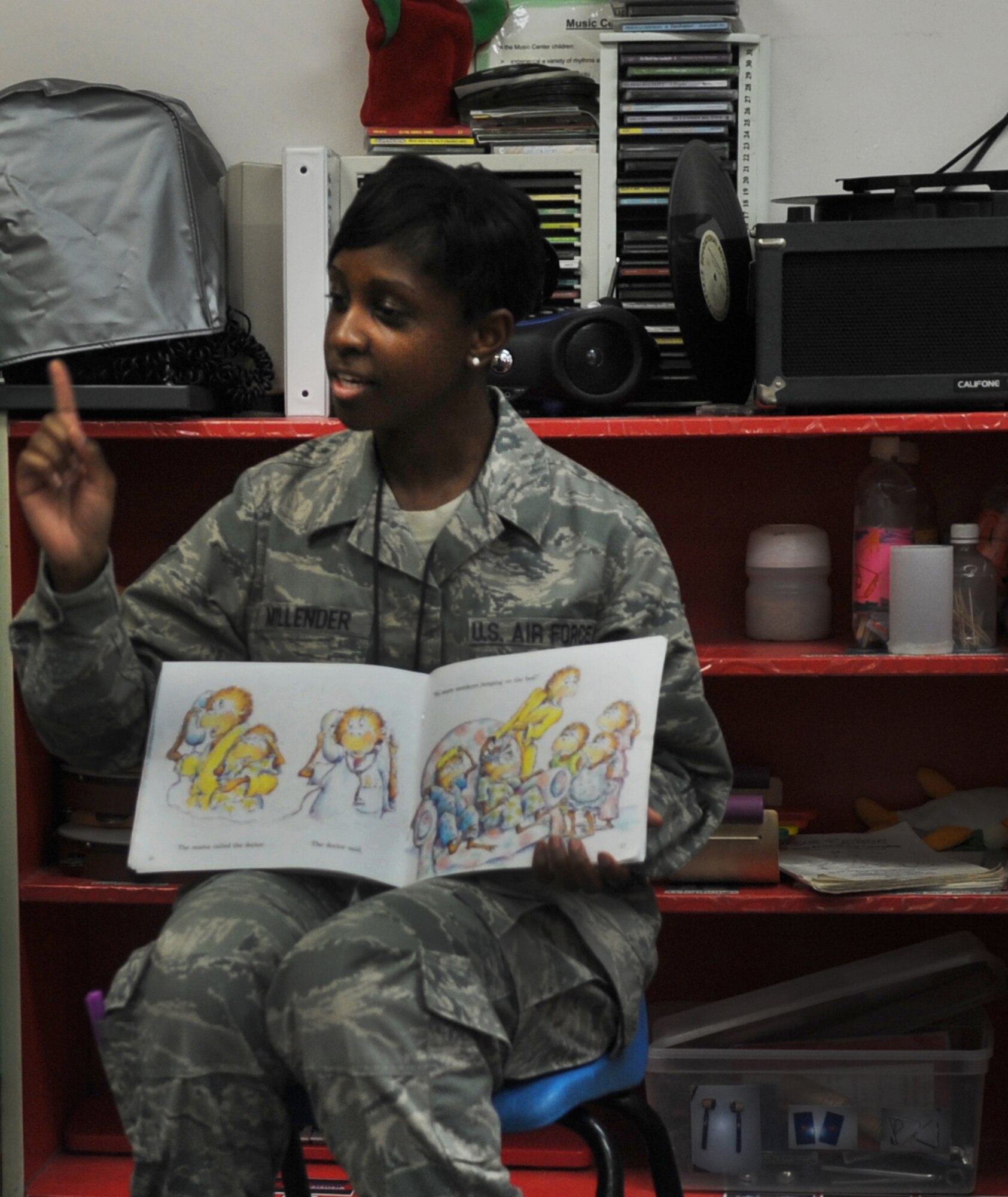 Staff Sgt. Jacquelyne Millender, 633rd Medical Operations Squadron mental health technician, uses her finger to emphatically illustrate a page in the book she is reading to children at the Langley Air Force Base, Va. Child Development Center, July 17, 2012. Millender actively engaged the children to participate during the reading. (U.S. Air Force photo by Senior Airman Jarad A. Denton/Released)