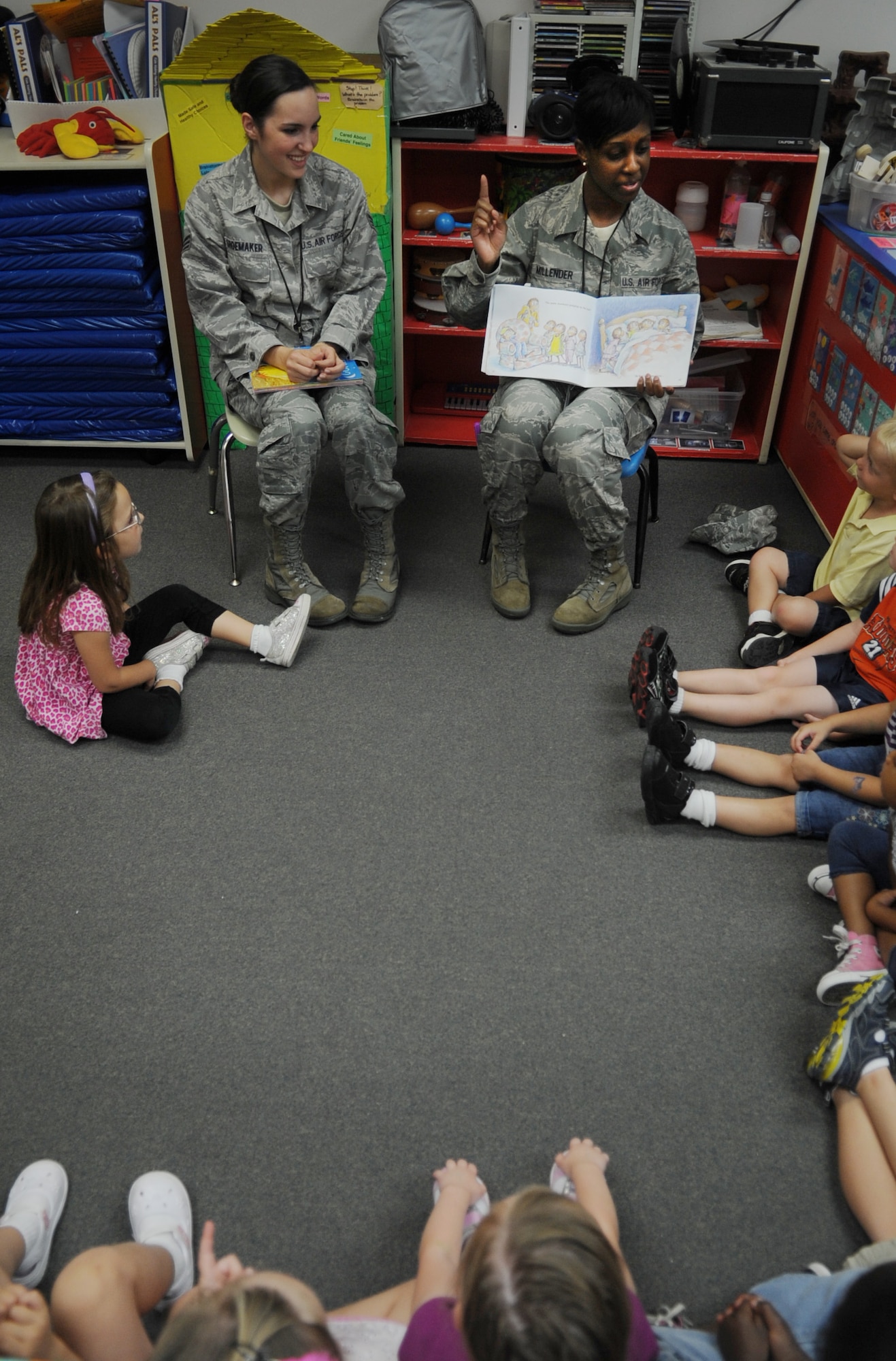 Staff Sgt. Jacquelyne Millender, right, and Senior Airman Sarah Shoemaker, both mental health technicians with the 633rd Medical Operations Squadron, read to children at the Langley Air Force Base, Va. Child Development Center, July 17, 2012. The volunteer program was sponsored by the Langley Family Advocacy Office in support of “Make a Difference to Children Month.” (U.S. Air Force photo by Senior Airman Jarad A. Denton/Released)