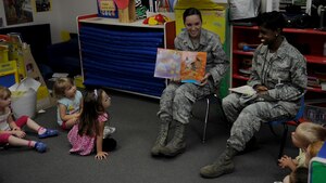 Senior Airman Sarah Shoemaker, left, and Staff Sgt. Jacquelyne Millender, both mental health technicians from the 633rd Medical Operations Squadron, read to children at the Langley Air Force Base, Va. Child Development Center, July 17, 2012. Shoemaker, who has volunteered to read to children twice, said she found both experiences to be extremely rewarding. (U.S. Air Force photo by Senior Airman Jarad A. Denton/Released)