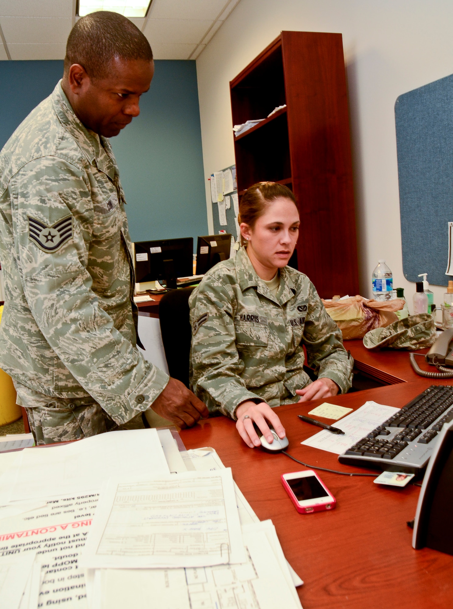 Air National Guard Staff Sgt. Columbus Cook, left, 116th Civil Engineering Squadron, reviews an AutoCAD drawing with Airman 1st Class Jennifer Harris, 202nd Engineering Installation Squadron, Robins Air Force Base, Ga., July 10, 2012.  Cook and Harris worked together to develop and produce a new user-friendly map system based on the Army's Military Grid Reference System.  The maps were created to help Airmen from Team Joint STARS more easily read and communicate grid coordinates during the unit's Operation Readiness Exercise.  ( National Guard photo by Master Sgt. Roger Parsons/Released)