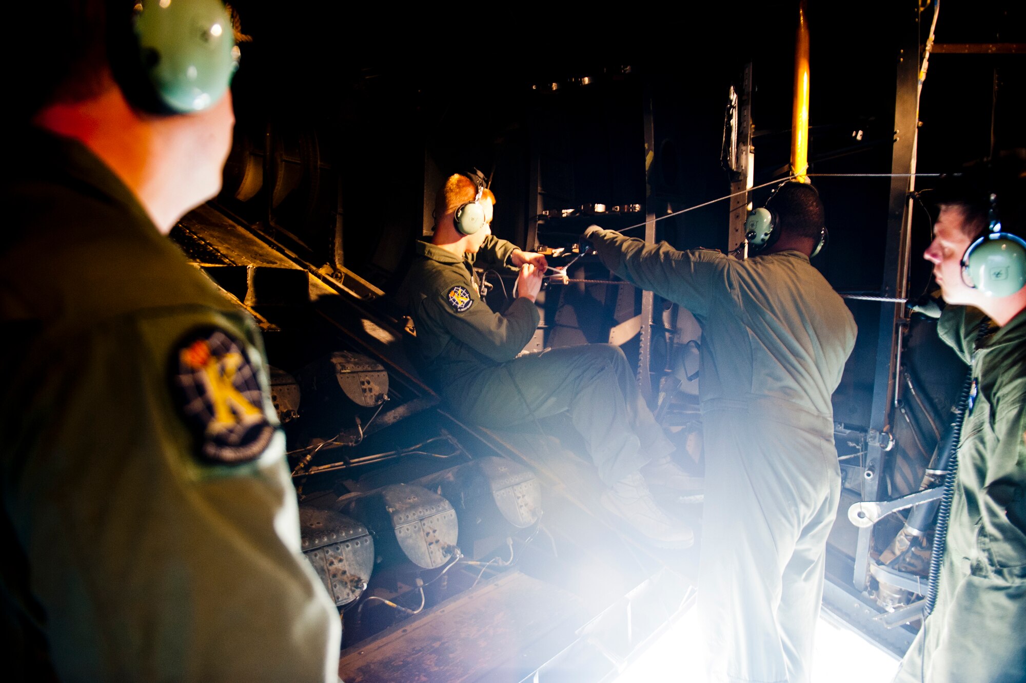U.S. Air Force Senior Airman Ben Haro and Tech. Sgt. Alfert Anderson, 71st Rescue Squadron loadmasters, rig a jump cable on an HC-130P Combat King July 16, 2012, at Moody Air Force Base, Ga. The Airmen and their crew prepared the aircraft for 38th RQS pararescumen and combat rescue officers who performed static-line jumps. (U.S. Air Force photo by Staff Sgt. Jamal D. Sutter/Released)