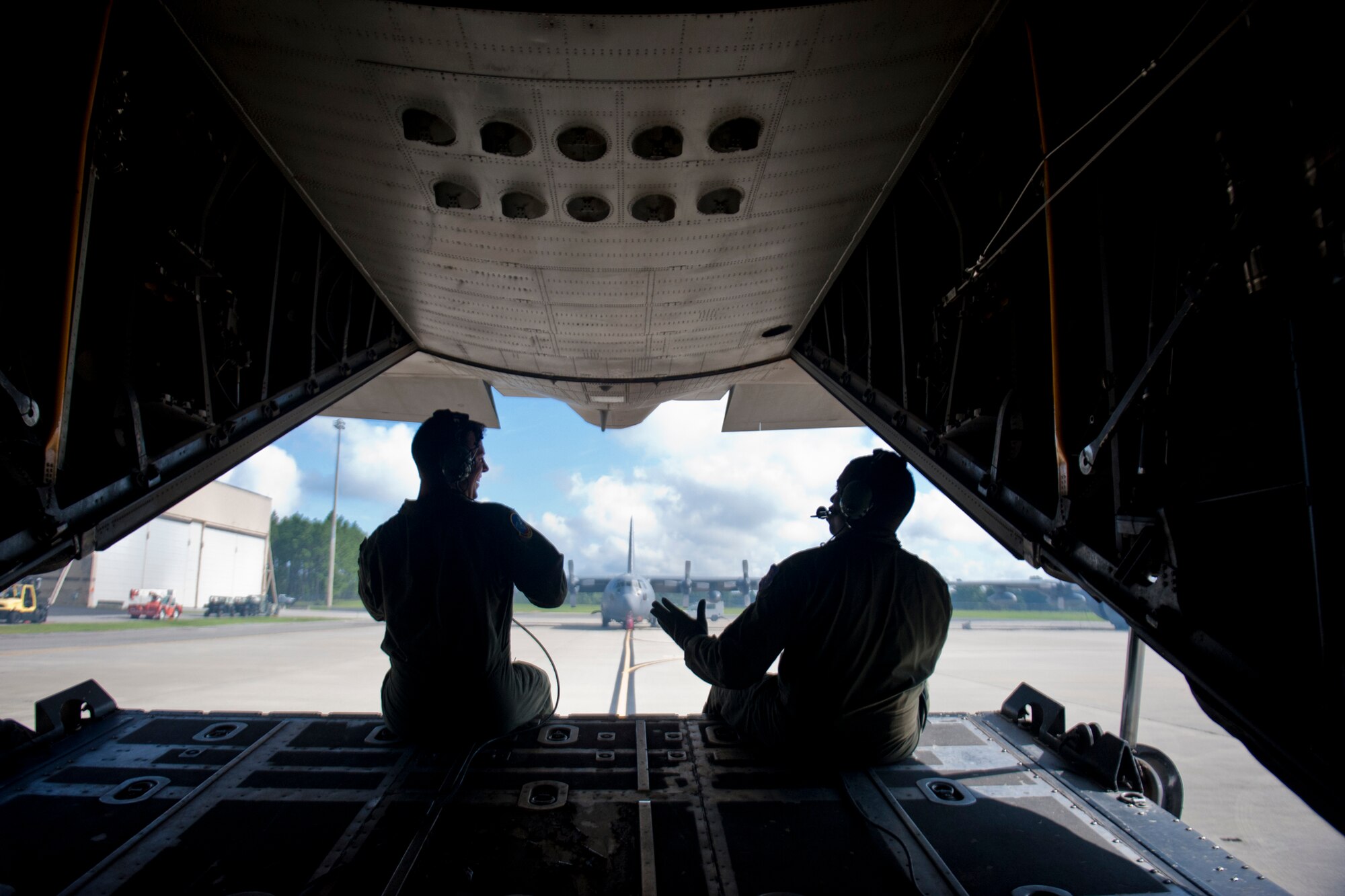 U.S. Air Force Staff Sgt. Tim Turner and Tech. Sgt. Alfert Anderson, 71st Rescue Squadron loadmasters, take a moment to talk while preparing an HC-130P Combat King for flight July 16, 2012, at Moody Air Force Base, Ga. 71st RQS loadmasters work with the 23d Logistics Readiness Squadron materiel maintenance flight when loading cargo and the 38th RQS and 820th Base Defense Group when helping conduct parachute jumps. (U.S. Air Force photo by Staff Sgt. Jamal D. Sutter/Released) 