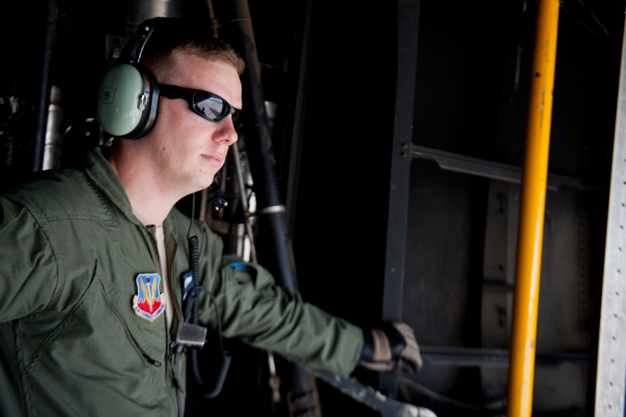 U.S. Air Force Senior Airman Jeremy Burgess, 71st Rescue Squadron loadmaster, takes a moment to look out the back of an HC-130P Combat King July 16, 2012, at Moody Air Force Base, Ga. As a loadmaster, Burgess supervises the loading of C-130s, including cargo and passengers. (U.S. Air Force photo by Staff Sgt. Jamal D. Sutter/Released) 