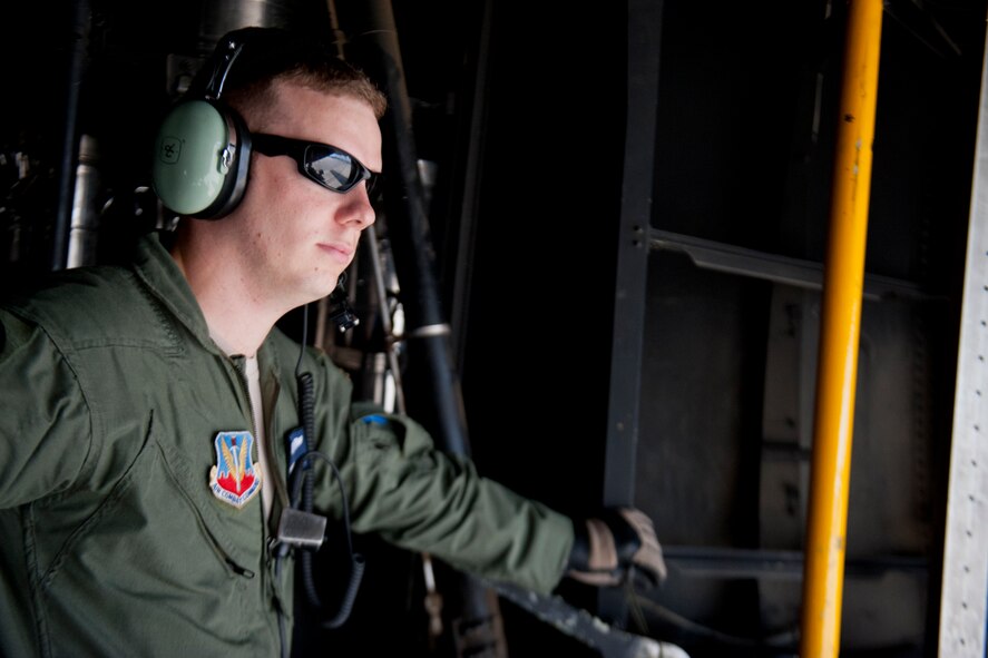 U.S. Air Force Senior Airman Jeremy Burgess, 71st Rescue Squadron loadmaster, takes a moment to look out the back of an HC-130P Combat King July 16, 2012, at Moody Air Force Base, Ga. As a loadmaster, Burgess supervises the loading of C-130s, including cargo and passengers. (U.S. Air Force photo by Staff Sgt. Jamal D. Sutter/Released) 