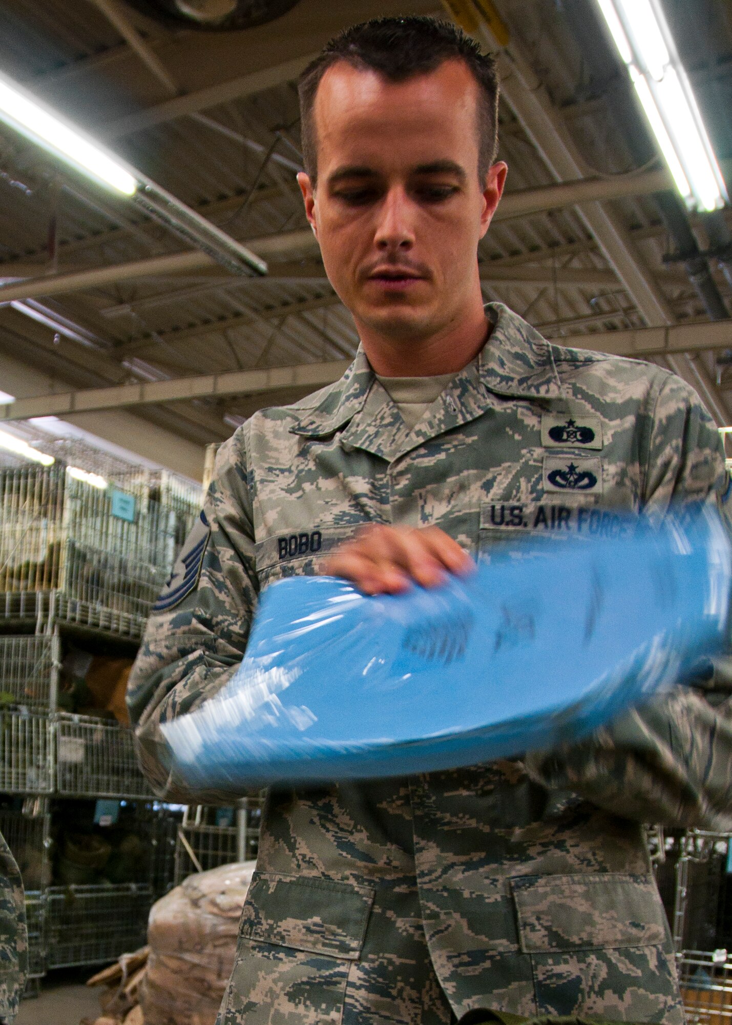 Master Sgt. Cory Bobo, 419th Civil Engineer Squadron unit deployment manager, looks at a bullet-proof vest chest plate used during predeployment training. Part of a UDM’s job is to make sure deploying Airmen have the required equipment for predeployment training. (U.S. Air Force photo/Tech. Sgt. Richard Gonzales)