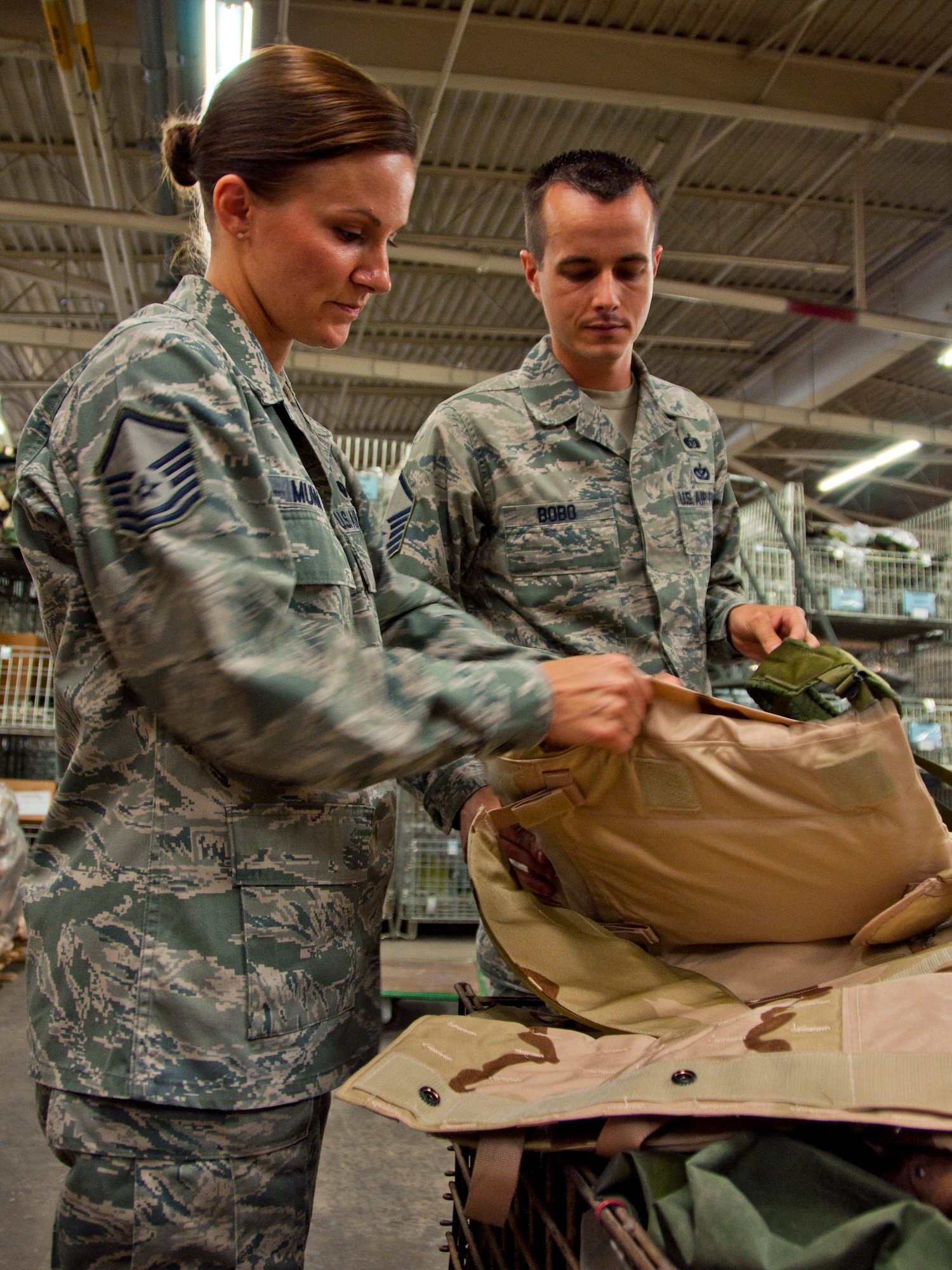 Master Sgt. Kylee Munn and Master Sgt. Cory Bobo, 419th FW unit deployment managers, inspect training gear used for pre-deployment training. UDMs are assigned to each of the wing’s squadrons and prepare Airmen to deploy. (U.S. Air Force photo/Tech. Sgt. Richard Gonzales)