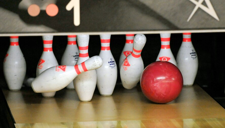A bowling ball strikes the pins for a strike July 13, 2012, at Eagle Lanes on Dover Air Force Base, Del. The strike was rolled during the Top 3 Bowling Tournament fundraiser that raised funds for the Senior NCO Induction Ceremony. (U.S. Air Force photo by Tech. Sgt. Chuck Walker)