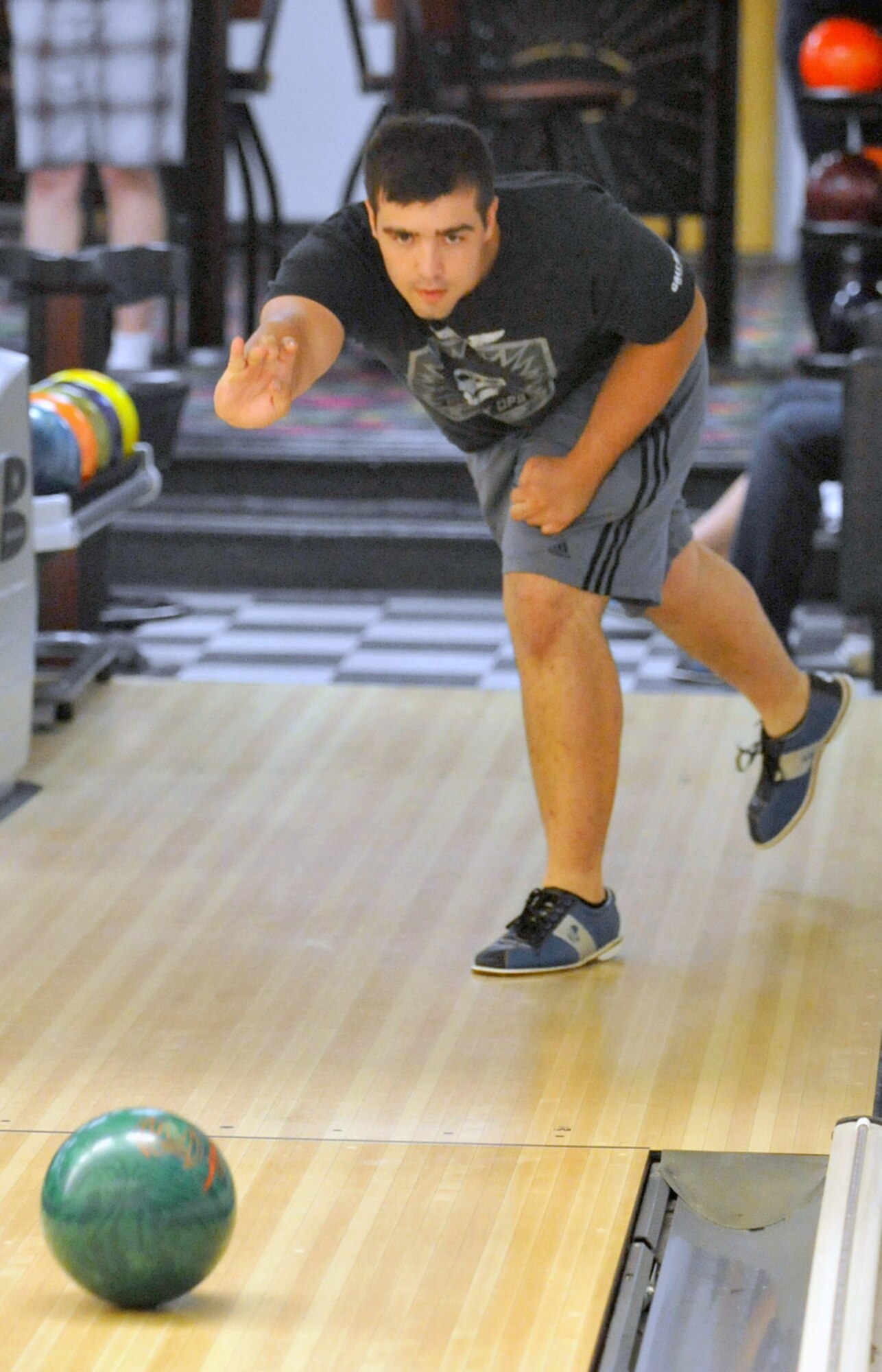 Phillip Diehl rolls the ball toward the pins during the Top 3 Bowling Tournament fundraiser July 13, 2012, at Eagle Lanes on Dover Air Force Base, Del. All proceeds from the fundraiser will go towards the Senior NCO Induction Ceremony. (U.S. Air Force photo by Tech. Sgt. Chuck Walker)