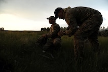 GARRISON, N.D. -- Staff Sgt. Brett Sipes and Staff Sgt. Brett Steinbrink, 5th Operational Support Squadron survival, evade, resistance and escape specialists, prepare some pyrotechnics signals during combat skills training at Camp Garrison, N.D., July 11, 2012. The refresher course helped sharpen aircrew member’s skills in order for them to be properly prepared for real world survival scenarios. (U.S. Air Force photo/Senior Airman Brittany Y. Auld)