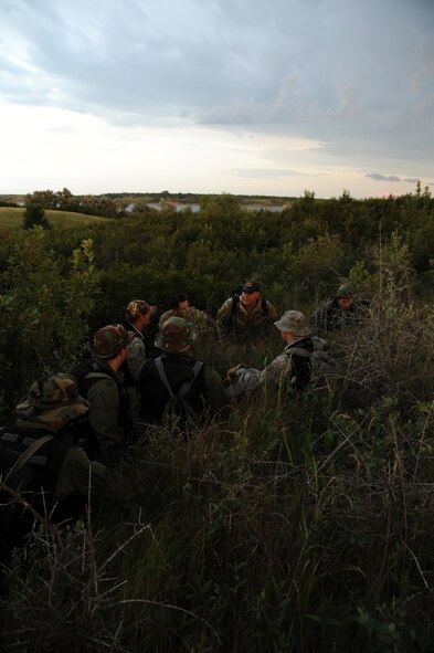 GARRISON, N.D. -- Staff Sgt. Brett Steinbrink, 5th Operational Support Squadron survival, evade, resistance and escape specialist briefed aircrew members from the 23rd Bomb Squadron and the 54th Helicopter Squadron on how to evade during combat skills training. The course went over basic survival skills including: wilderness living, shelter construction, fire building, map and compass navigation, backpacking, food and water procurement, wilderness medicine and first aid, signaling and rescue techniques and escape and evasion. (U.S. Air Force photo/Senior Airman Brittany Y. Auld)