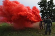 GARRISON, N.D. -- Aircrew members from the 23rd Bomb Squadron and the 54th Helicopter Squadron shoot smoke signals during combat skills training here, July 11. The course went over basic survival skills including: wilderness living, shelter construction, fire building, map and compass navigation, backpacking, food and water procurement, wilderness medicine and first aid, signaling and rescue techniques and escape and evasion. (U.S. Air Force photo/Senior Airman Brittany Y. Auld)