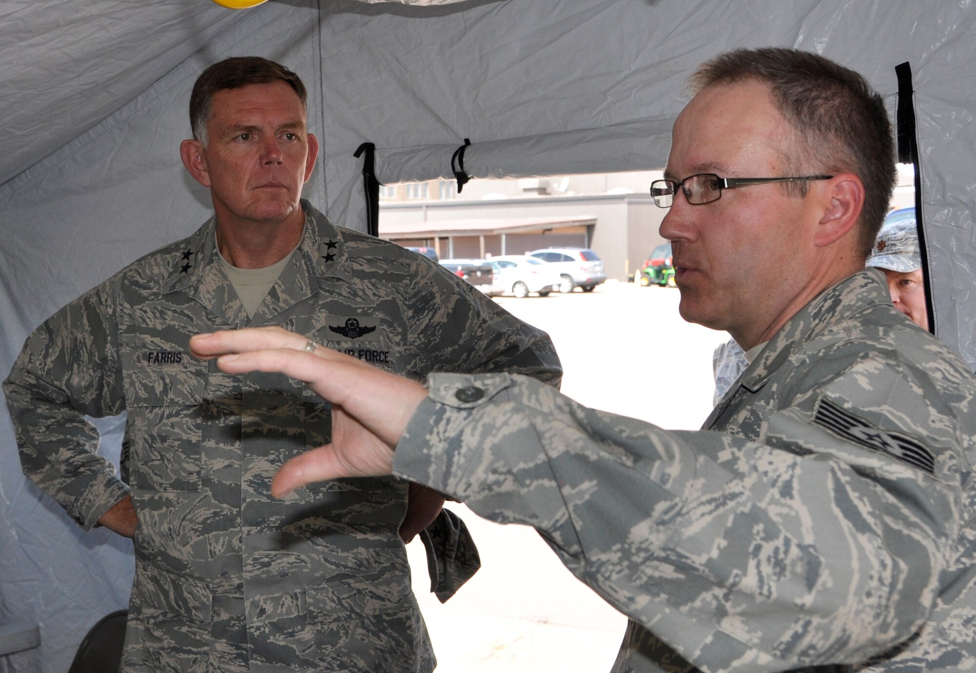 Air Force Reserve Tech. Sgt. Gregory Aubuchon highlights the major benefits of the Joint Incident Site Communication Capability, or "JISCC" system to Maj. Gen. Wallace W. “Wade” Farris, Jr., as the general toured the 302nd Airlift Wing July 15 at Peterson Air Force Base, Colo. Farris, who commands the 22nd Air Force, the parent organization to the 302nd Airlift Wing, visited the wing to see its mission firsthand as well as gain a better understanding of its involvement with the recent Modular Airborne Fire Fighting System, or "MAFFS" activation to battle the nearby Waldo Canyon Fire. The general also coined a number of Air Force Reservists who had gone above and beyond in their respective 302nd AW positions. Farris visited the wing July 14-17. Aubuchon is assigned to the 302nd Communications Flight. (U.S. Air Force photo/Staff Sgt. Stephen J. Collier)