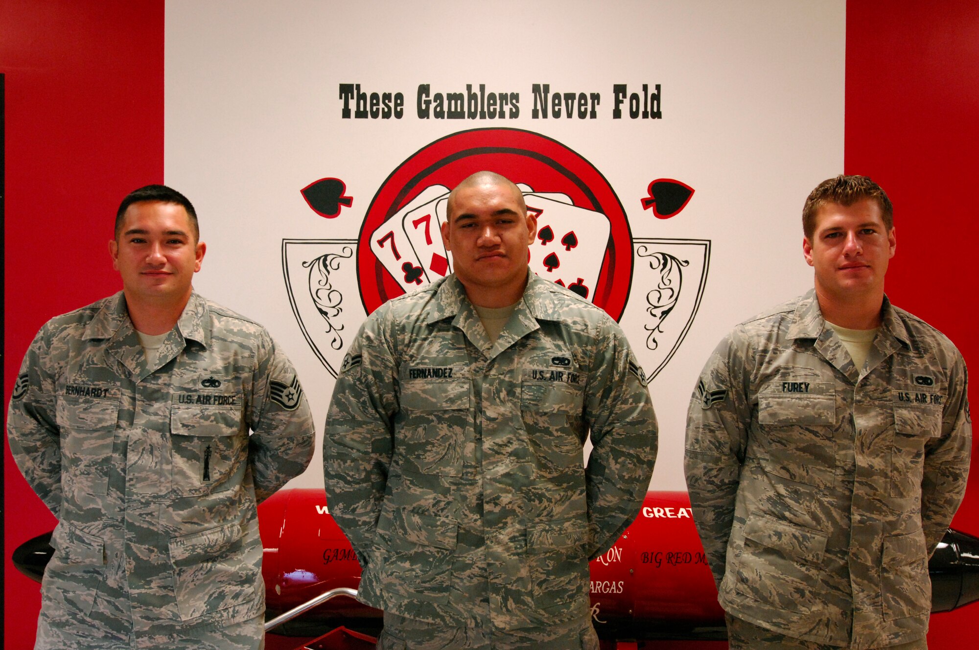 U.S. Air Force Staff Sgt. William Bernhardt (left), Airman 1st Class Kameran Fernandez, and Airman 1st Class Matthew Furey, 20th Aircraft Maintenance Squadron load crew members, pose for a photo after winning a quarterly load crew competition at Shaw Air Force Base, S.C. July 16, 2012. Load crew competitions are held once a quarter, testing the speed and precision of each load crew participant. (U.S. Air Force photo by Airman 1st Class Ashley L. Gardner/ Released)
