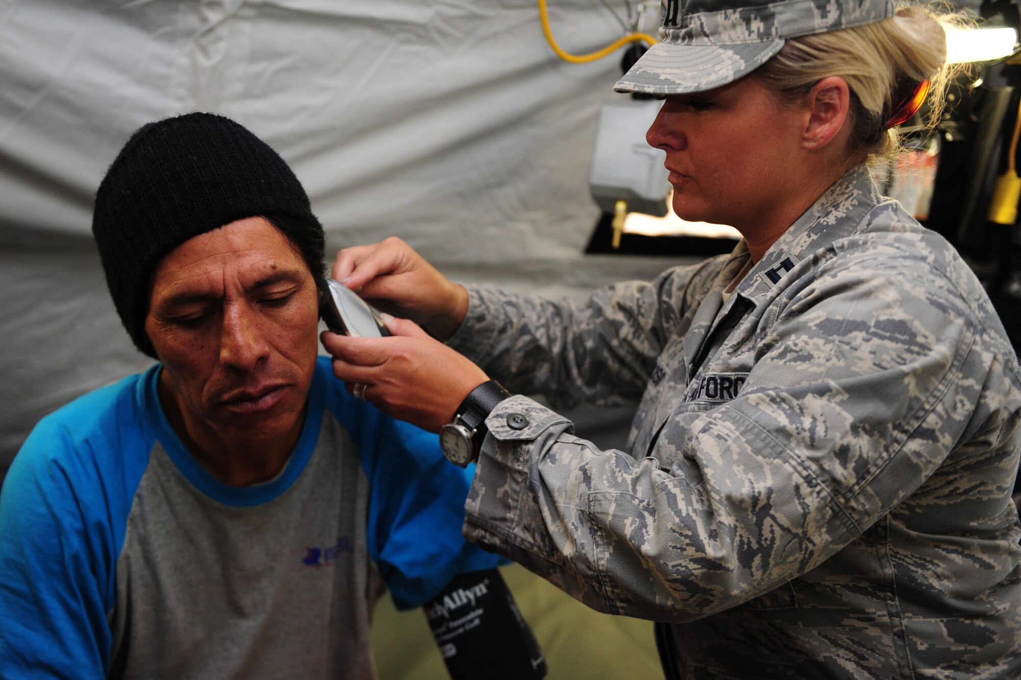 U.S. Air Force Capt. Jody Huss, right, checks the vital signs of a Peruvian patient at a health response team Expeditionary Medical Support mobile field hospital in Huancavelica, Peru, July 2, 2012, during New Horizons 2012. Huss, deployed from Langley Air Force Base, Va., is participating in a U.S. Southern Command-sponsored annual series of joint humanitarian assistance exercises to provide humanitarian and medical services. (U.S. Air Force photo by Staff Sgt. Michael C. Zimmerman/Released)