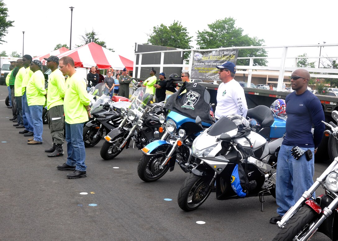 A line of 13 motorcycle riders stand at parade rest during a moment of reflection at Joint Base Andrews’ Motorcycle Safety Day on July 13. The riders represented the 13 motorcycle-related fatalities the Air Force has experienced this year. One-by-one, each rider stepped forward as the name of the Airman they represented and the events surrounding their fatality were announced to the audience. (U.S. Air Force photo/Senior Airman Lindsey A. Porter)
