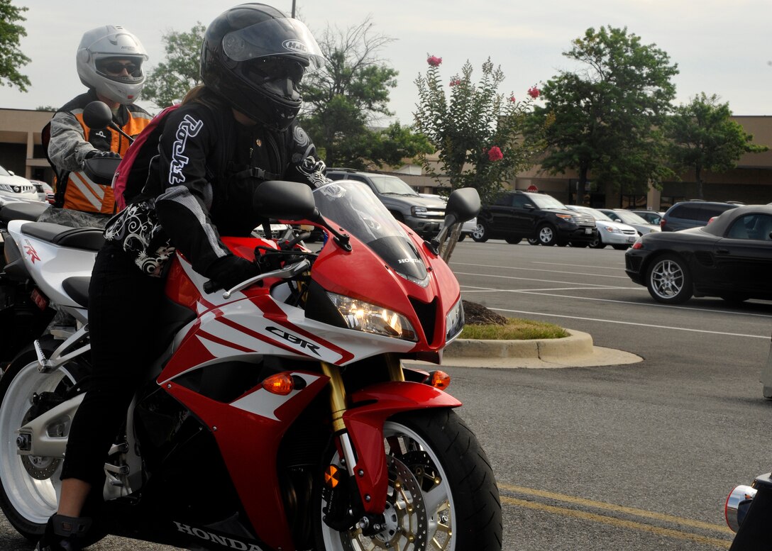 Fully clad in motorcycle Proper Protective Equipment (PPE), a female motorcyclist prepares for a group ride on July 13. More than 30 motorcyclists from Andrews and surrounding areas participated in the group ride which kicked off Joint Base Andrews’ Motorcycle Safety Day. (U.S. Air Force photo/Senior Airman Lindsey A. Porter)