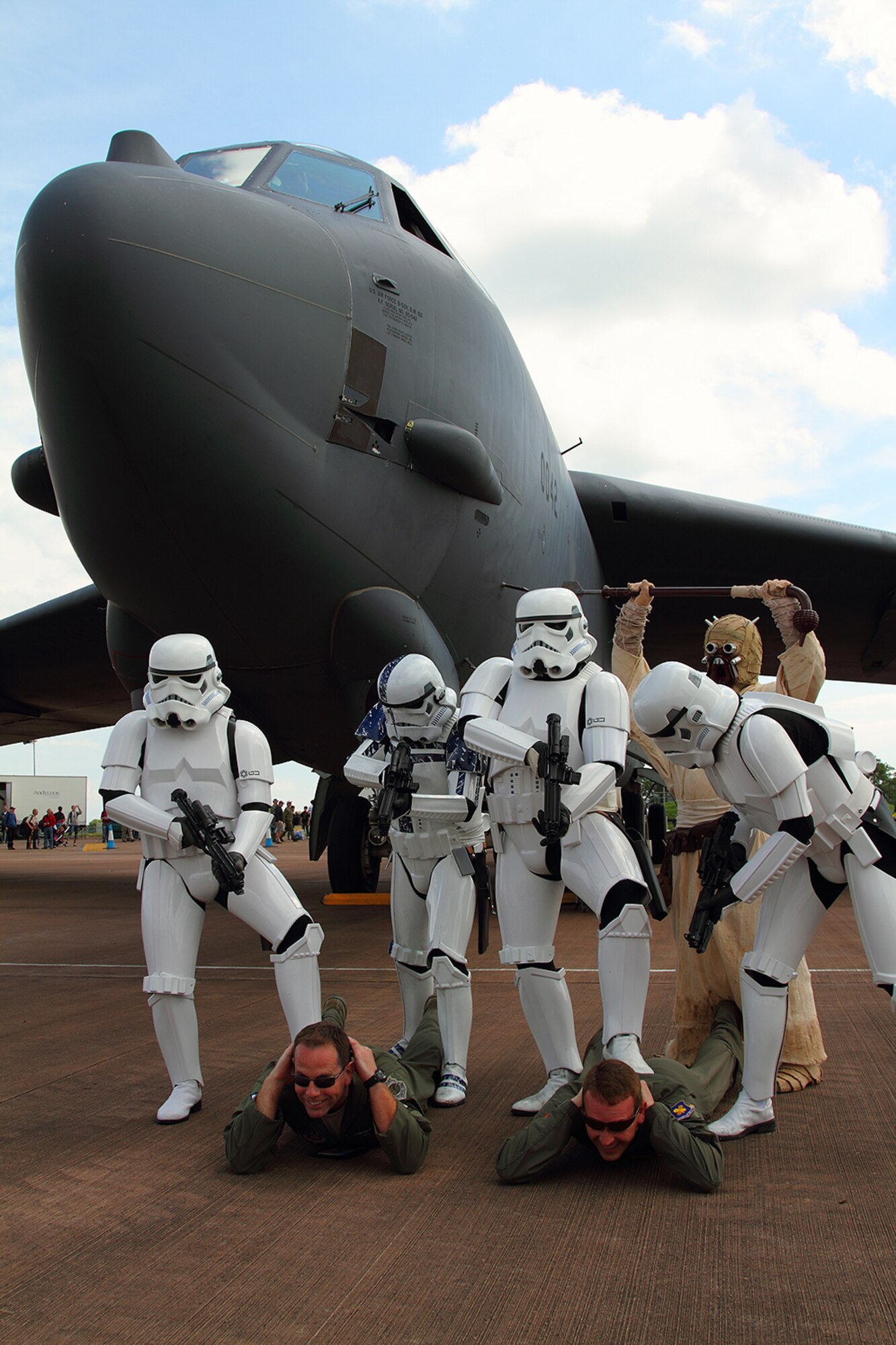 Two Airmen from the 93rd Bomb Squadron, 307th Bomb Wing, Barksdale Air Force Base, La., (who shall remain nameless for obvious reasons) attempt to negotiate standing privileges with a group disgruntled Imperial stormtroopers from the Galactic Empire, who just happen to be visiting the Royal International Air Tattoo 2012, RAF Fairford, England, July 8, 2012. During a brief discussion on the capabilities of the B-52 Stratofortress verses the TIE Heavy Bomber series used by the Galactic Empire, things got a little heated. Payload notwithstanding, B-52s have been in active service since 1955. The deciding factor came when the Airmen were informed that the TIE Bomber could be used in space and atmospheric conditions. (Courtesy photo by Roel Reijne)